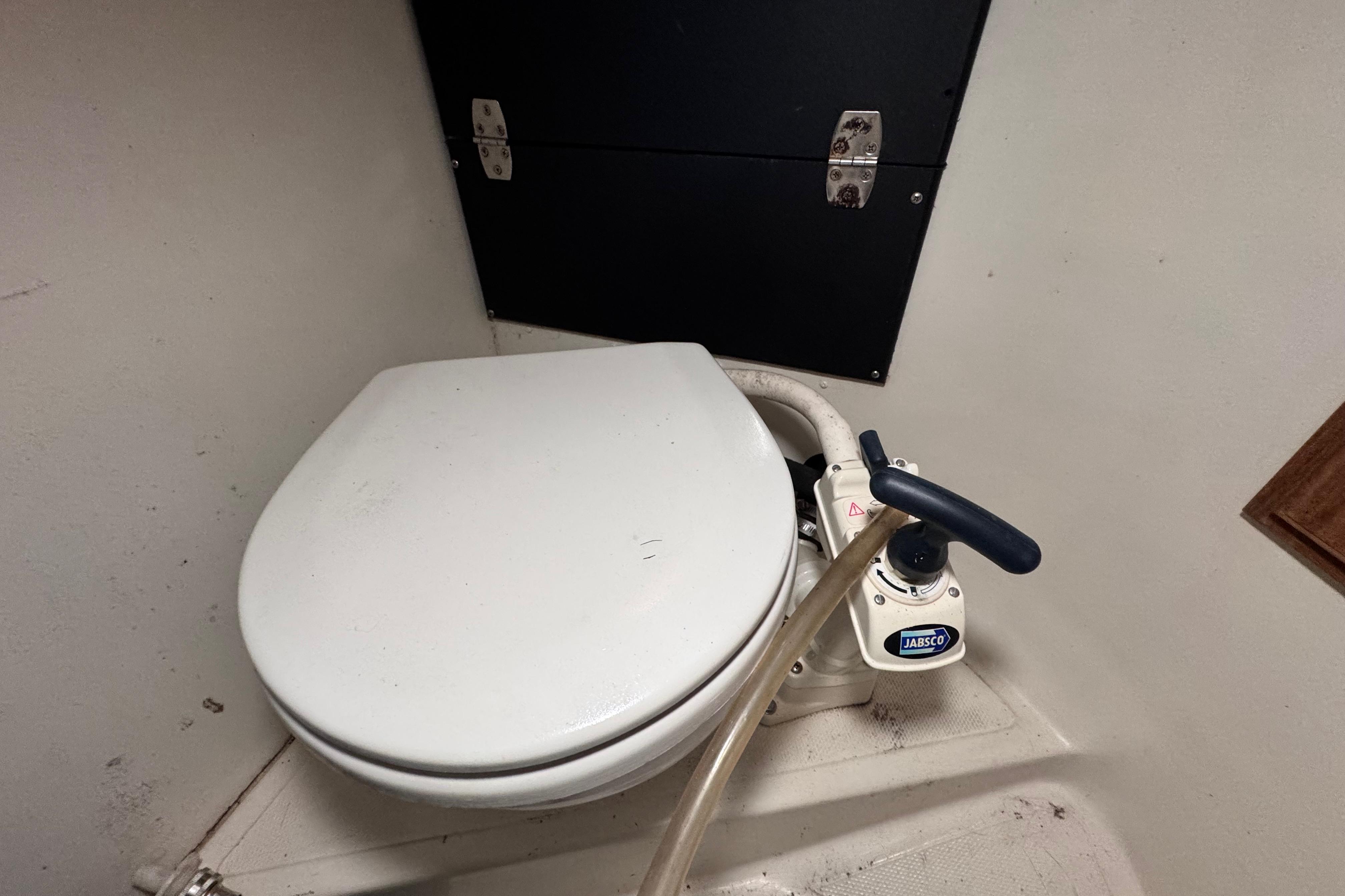 Marine toilet in a 1972 Morgan 35 sailboat, featuring a manual pump handle.