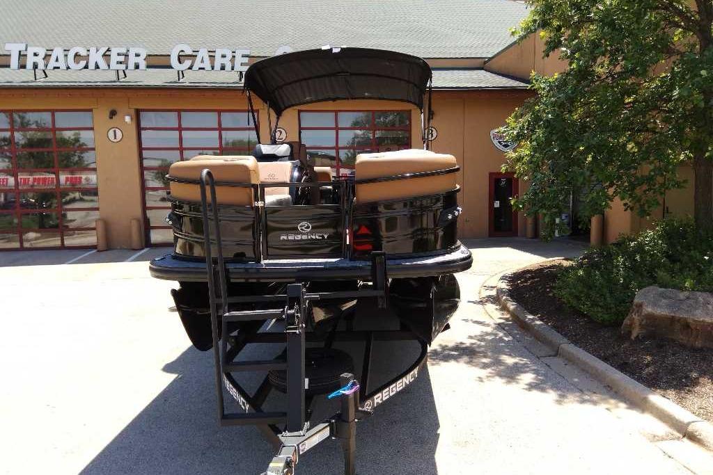 2026 Regency 230 DL boat parked outside Tracker Care facility.