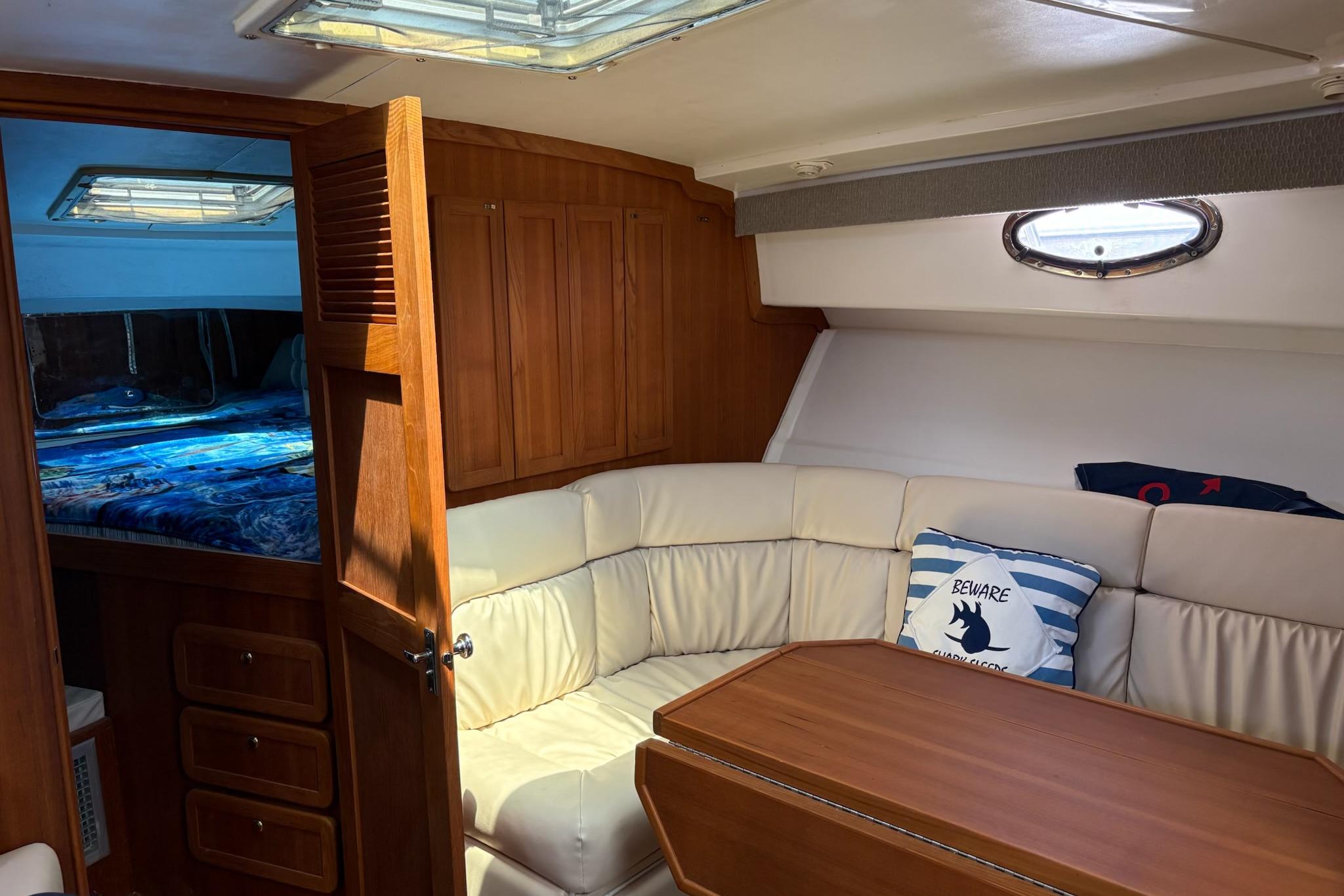 Interior of 2008 Stamas 370 Express yacht with cozy seating and wooden accents.