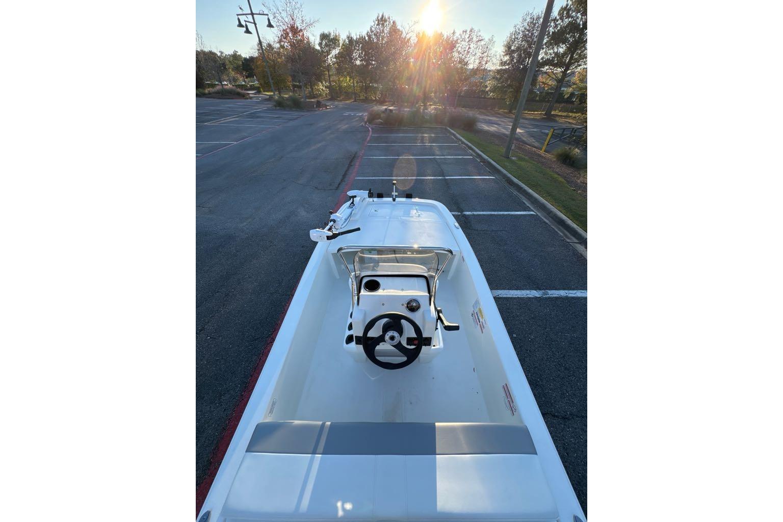 2026 Mako Pro Skiff 13 CC boat parked in a sunlit lot.