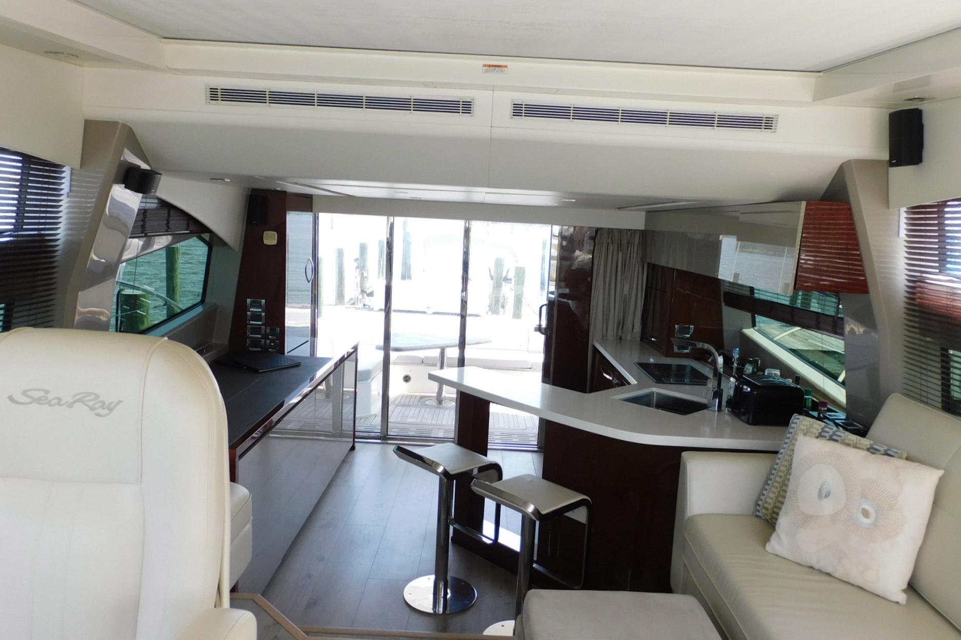 Luxurious interior of 2019 Sea Ray L550 yacht with modern kitchen and seating area.