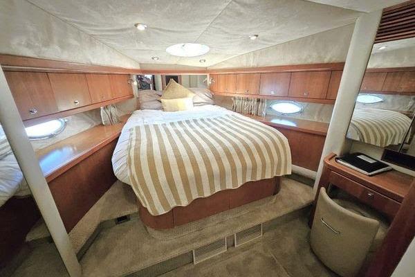 Luxurious cabin interior of 2005 Sunseeker Manhattan 66 yacht with cozy bed and elegant decor.