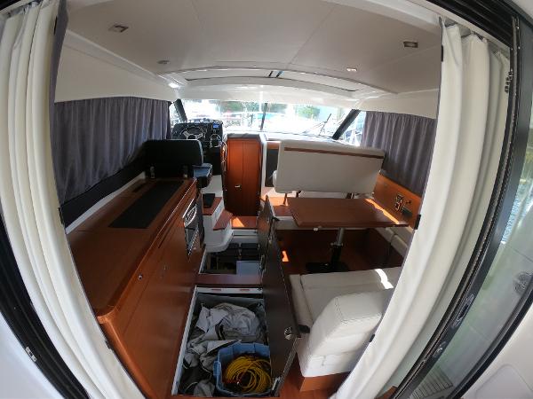 2017 Jeanneau NC 11 interior with modern kitchen and seating area.