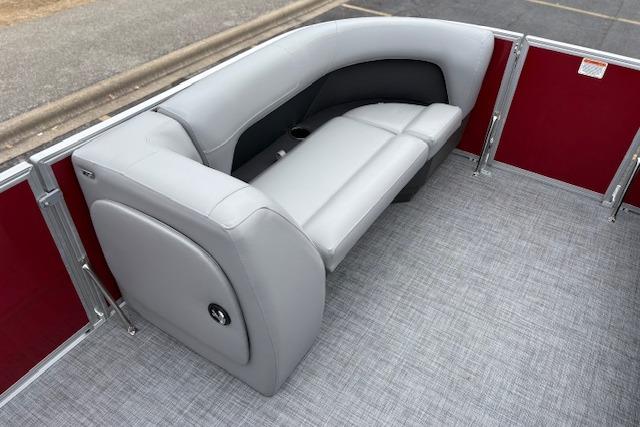 2026 Sun Tracker Party Barge 18 DLX interior with gray seating and red paneling.