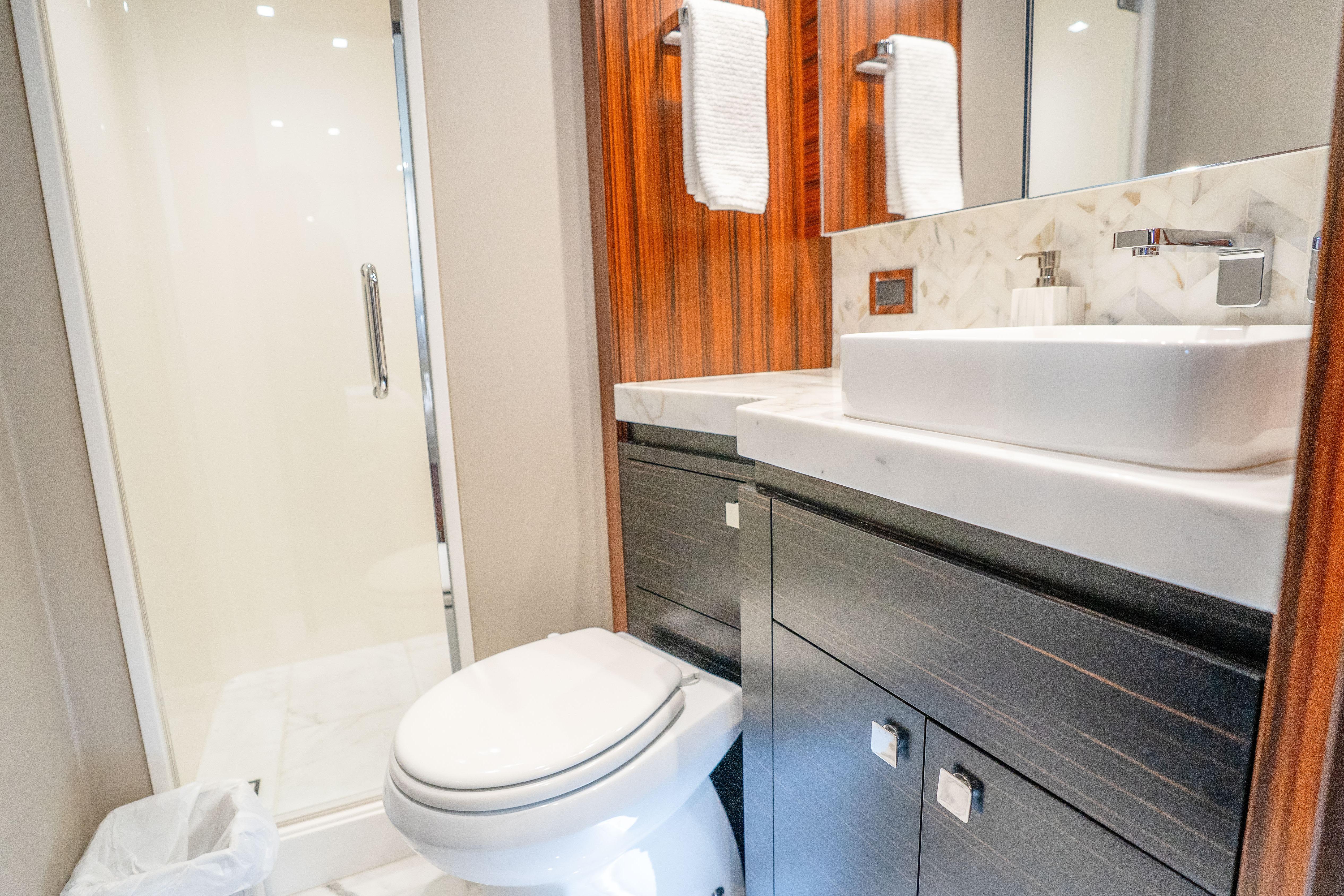 Luxurious bathroom in 2021 Hatteras M75 Panacera yacht with modern fixtures and elegant design.