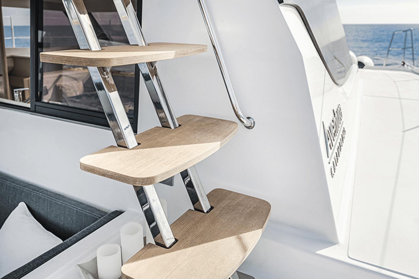 Modern wooden steps on Aventura 37 yacht, 2026 model, with ocean view.
