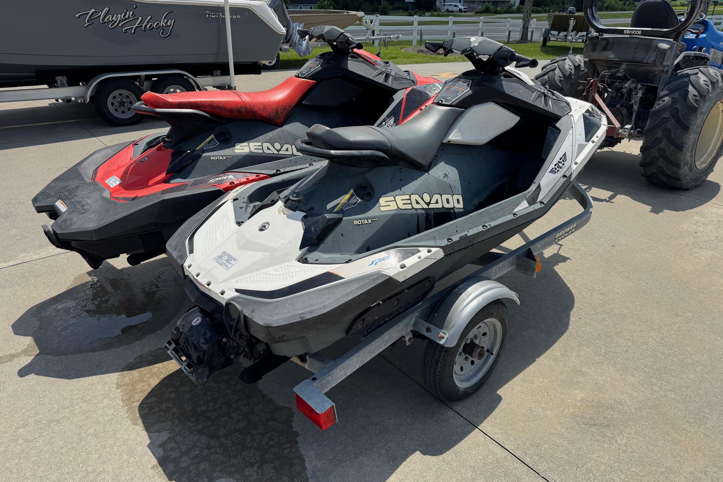 2017 Sea-Doo Spark 2up jet skis on a trailer, parked outdoors.