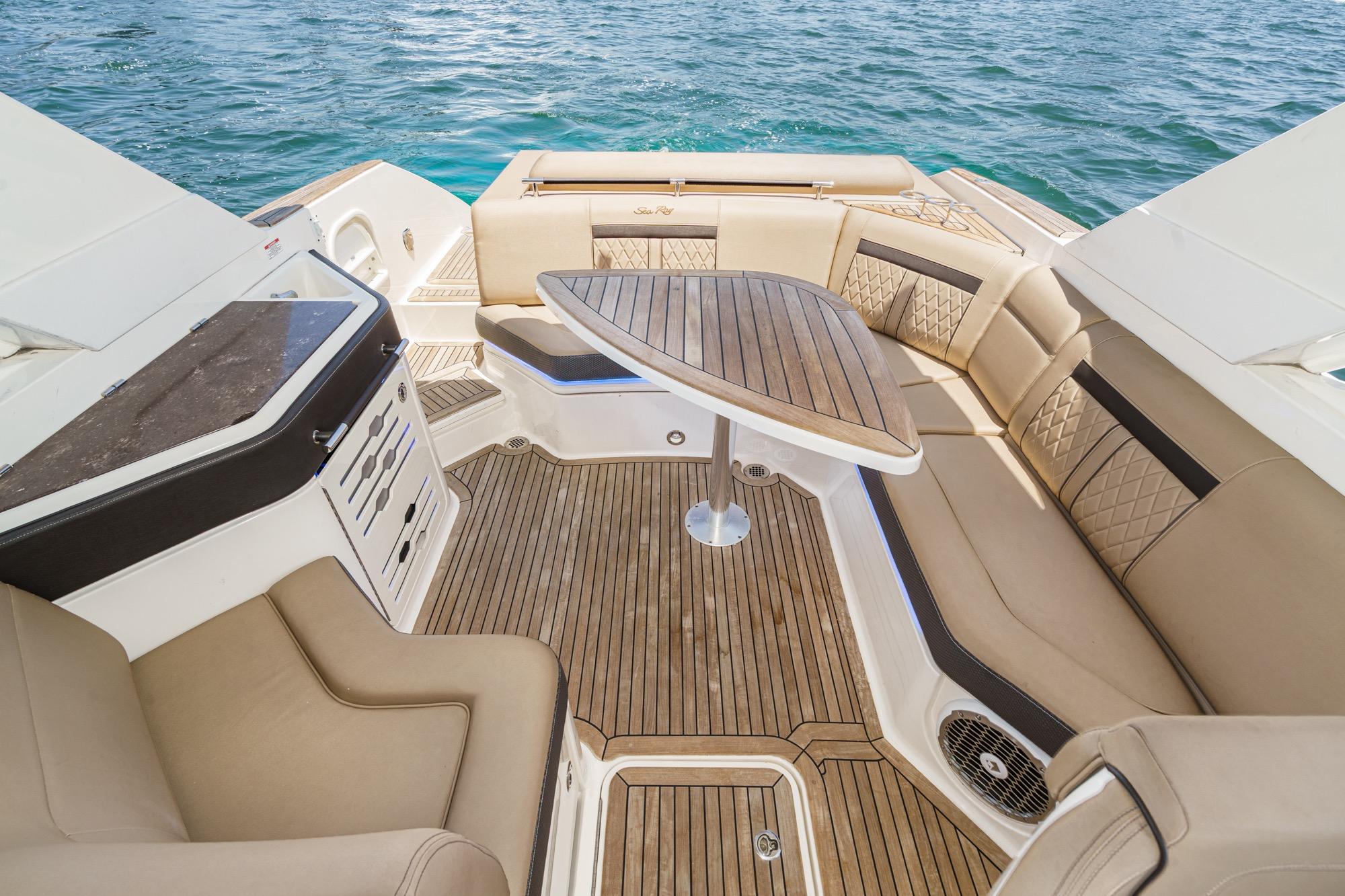 Luxurious 2018 Sea Ray SLX 310 boat interior with elegant seating and wooden table.