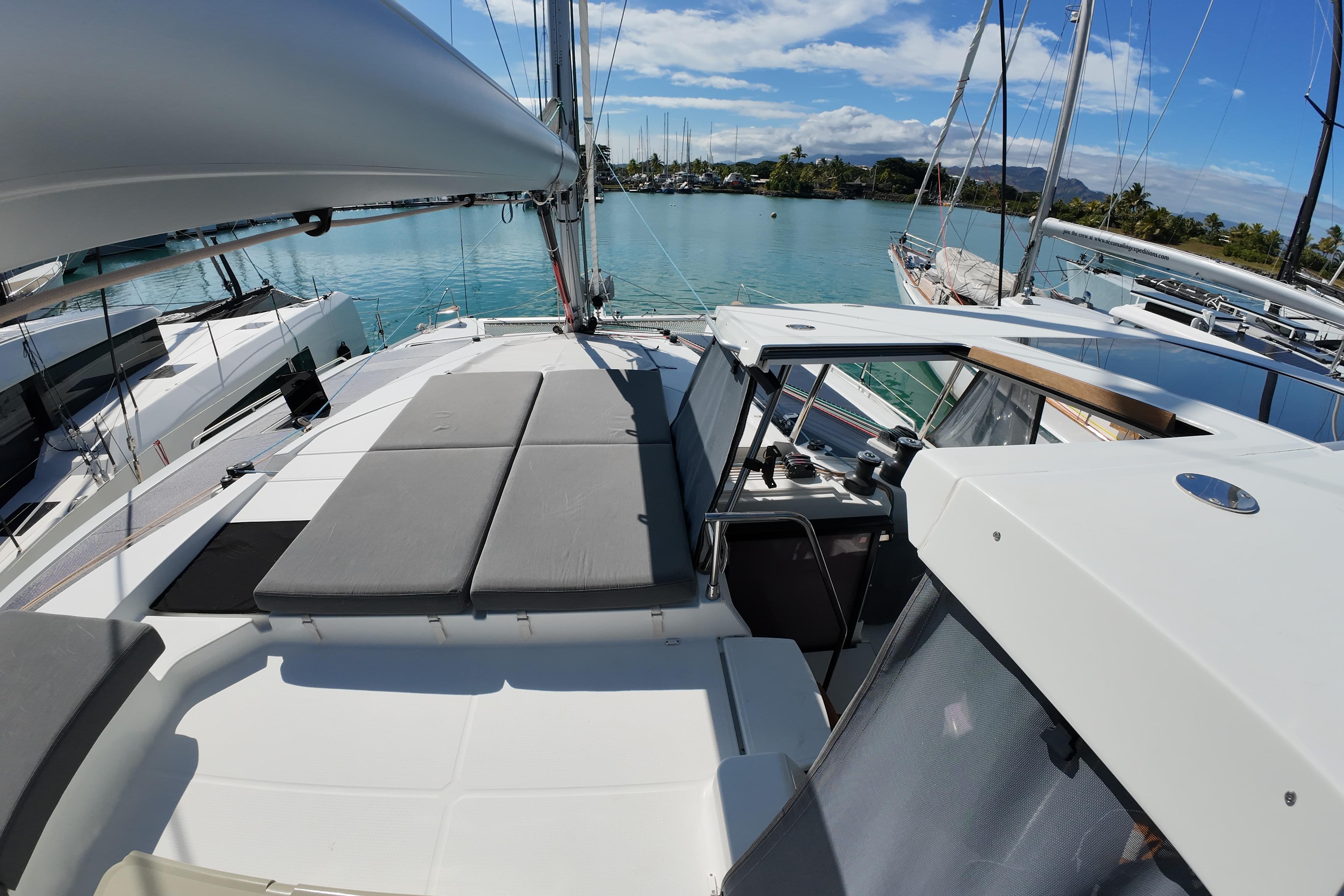 2022 Fountaine Pajot Tanna 47 catamaran docked in a serene marina setting.