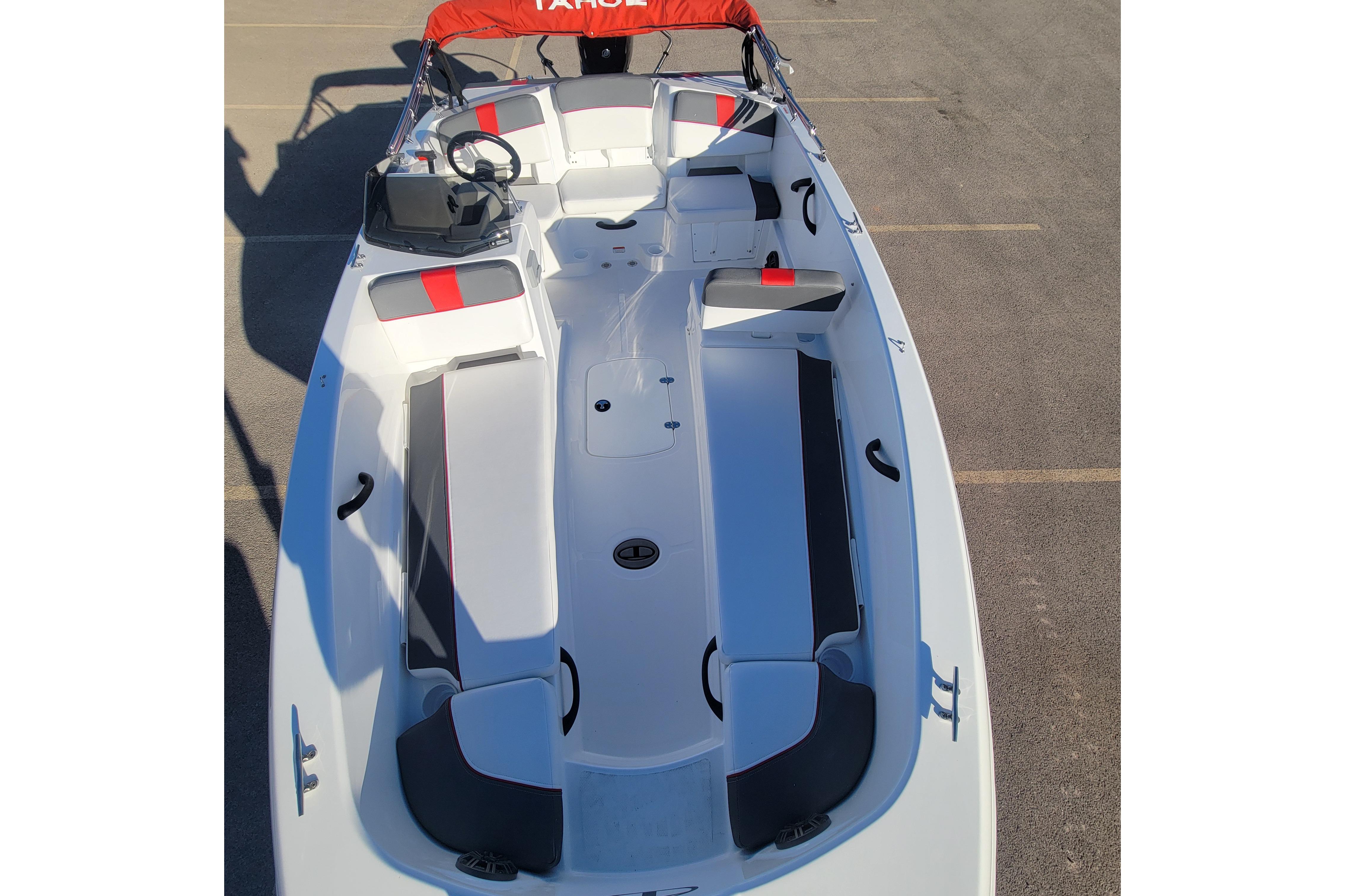 2026 Tahoe T18 boat interior with red and gray seating, steering console, and canopy.