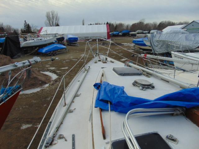 1979 Hinterhoeller Niagara 35 sailboat on land, surrounded by covered boats.
