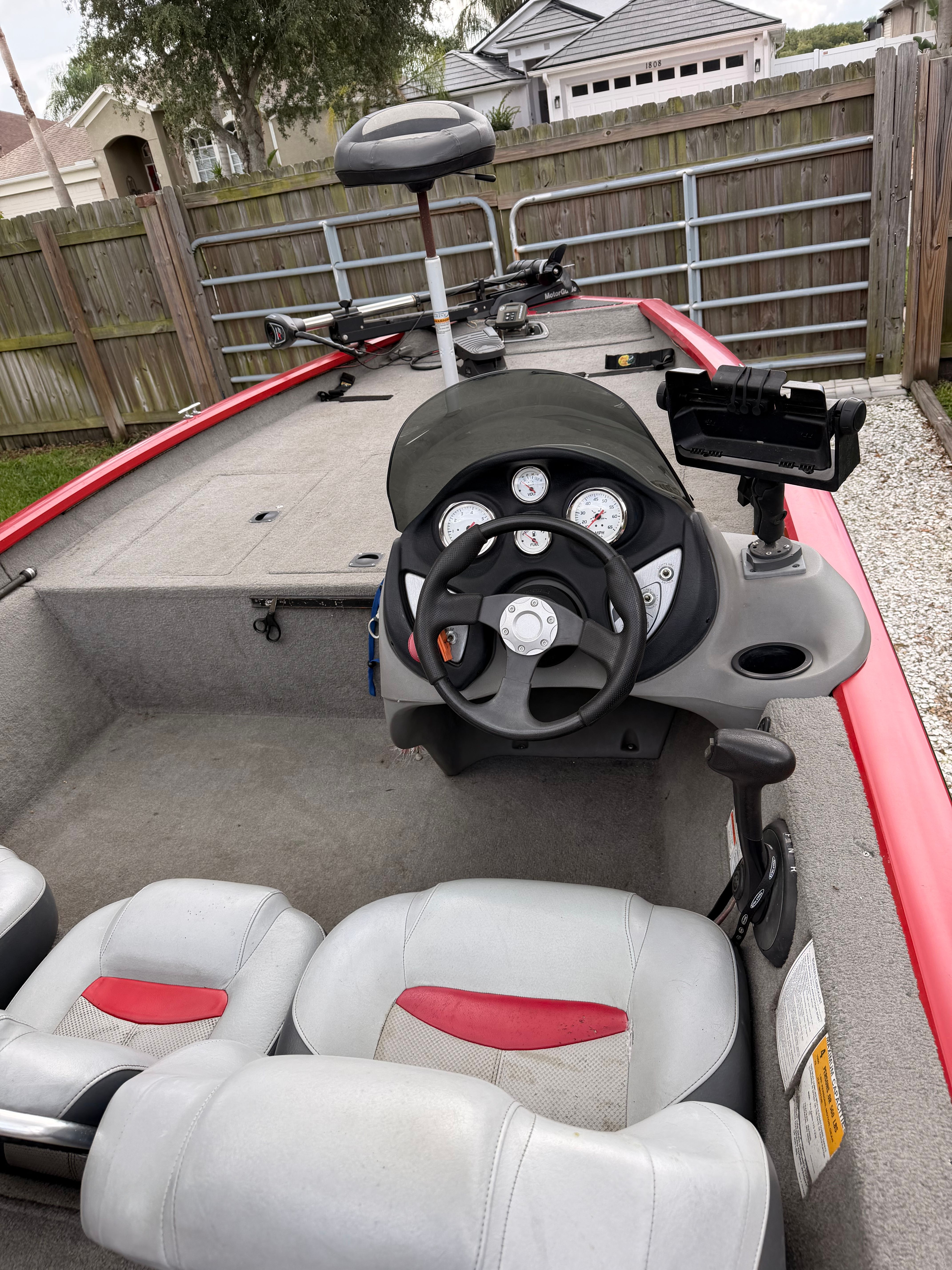 The image shows the cockpit of a 2011 Bass Tracker PRO TEAM 175 TXW with gray seats.