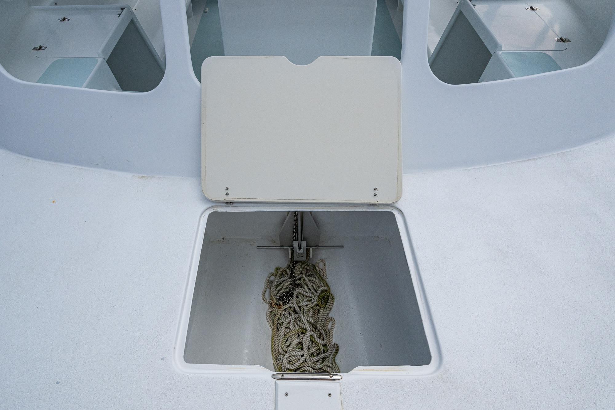Anchor storage compartment on 2019 Aventura 31 Cat boat with rope inside.