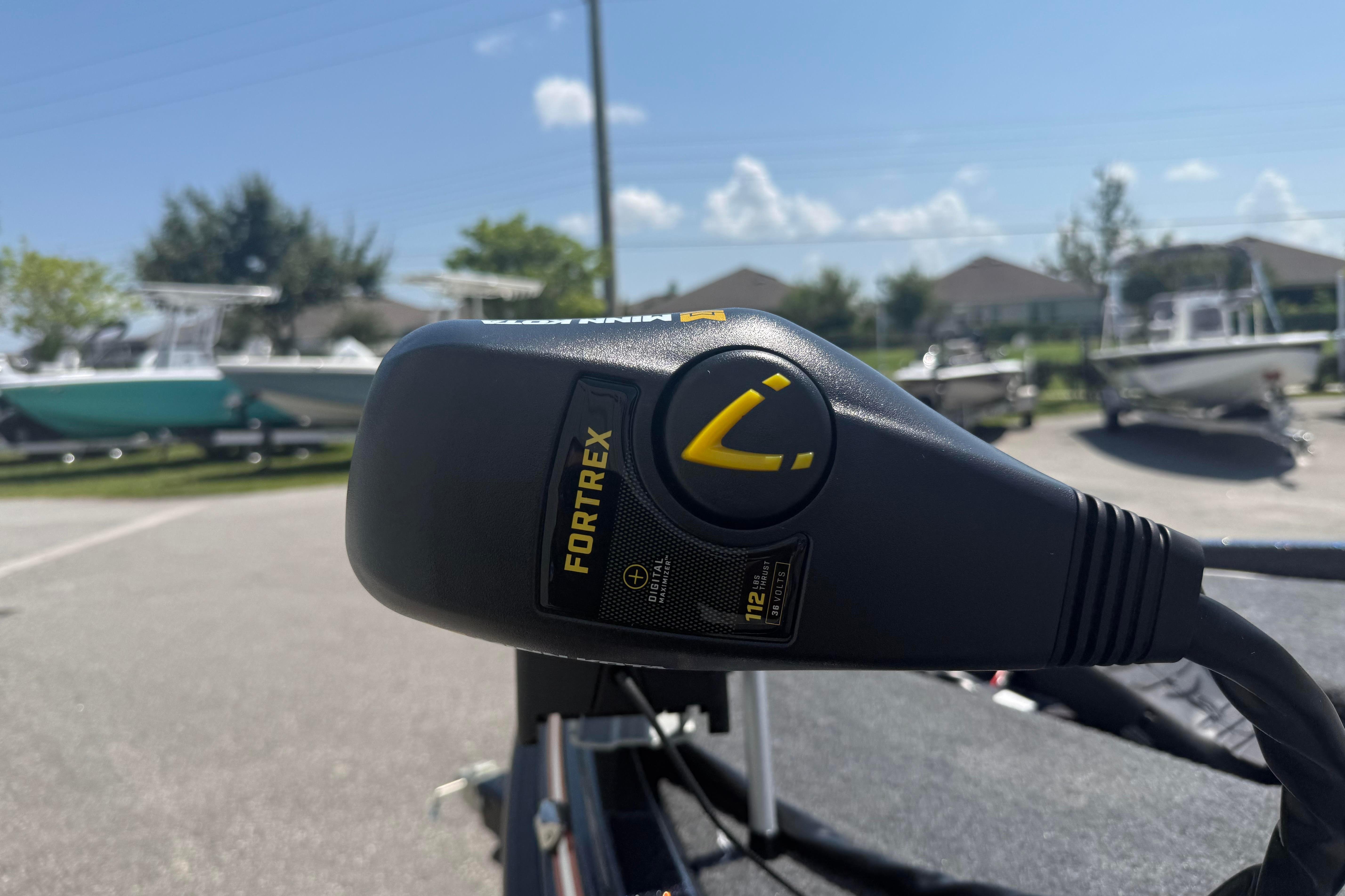 Close-up of Fortrex motor on 2027 Phoenix 819 ZXL boat in sunny marina.