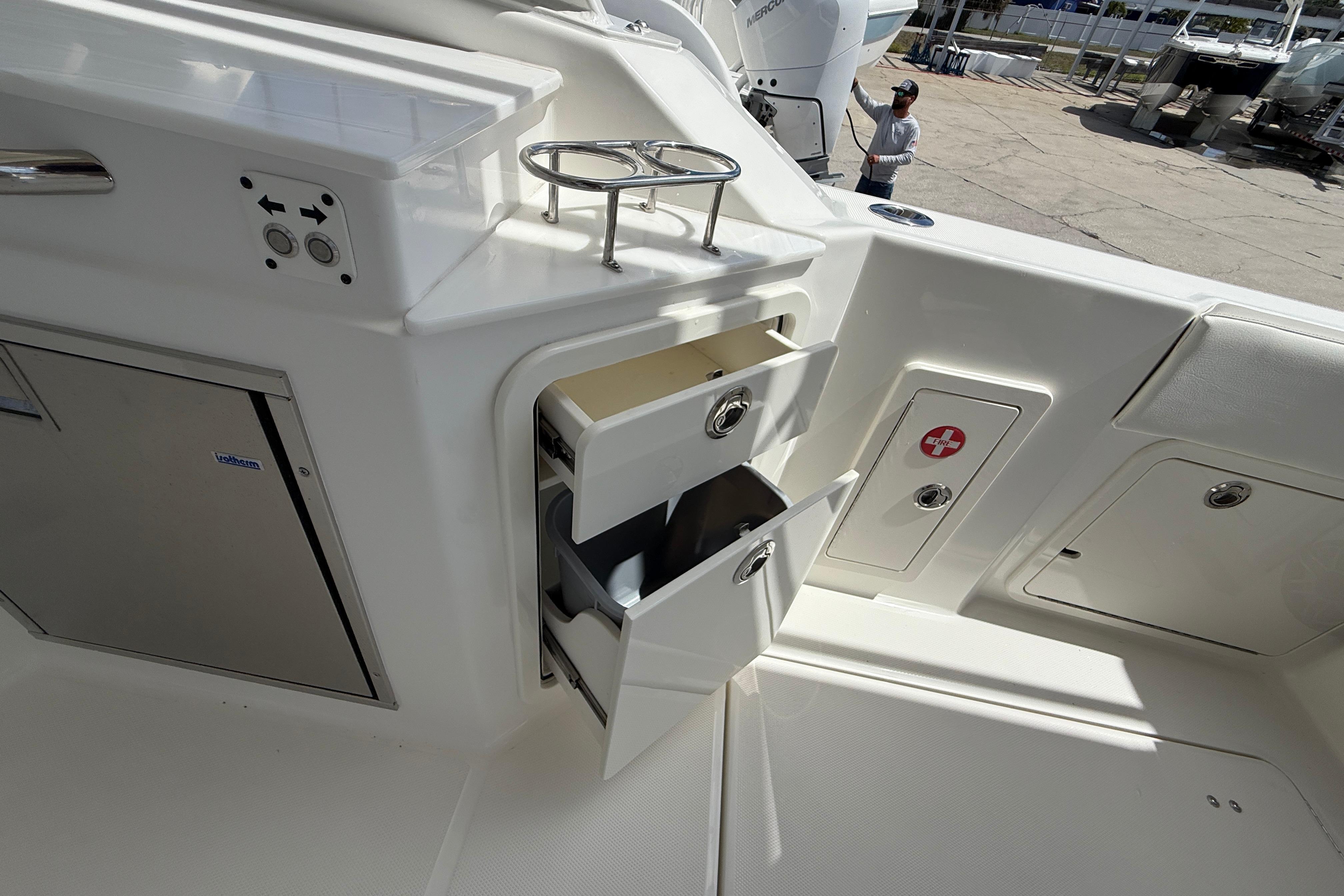 Interior of 2026 World Cat 400 DC-X Island boat with storage compartments open.