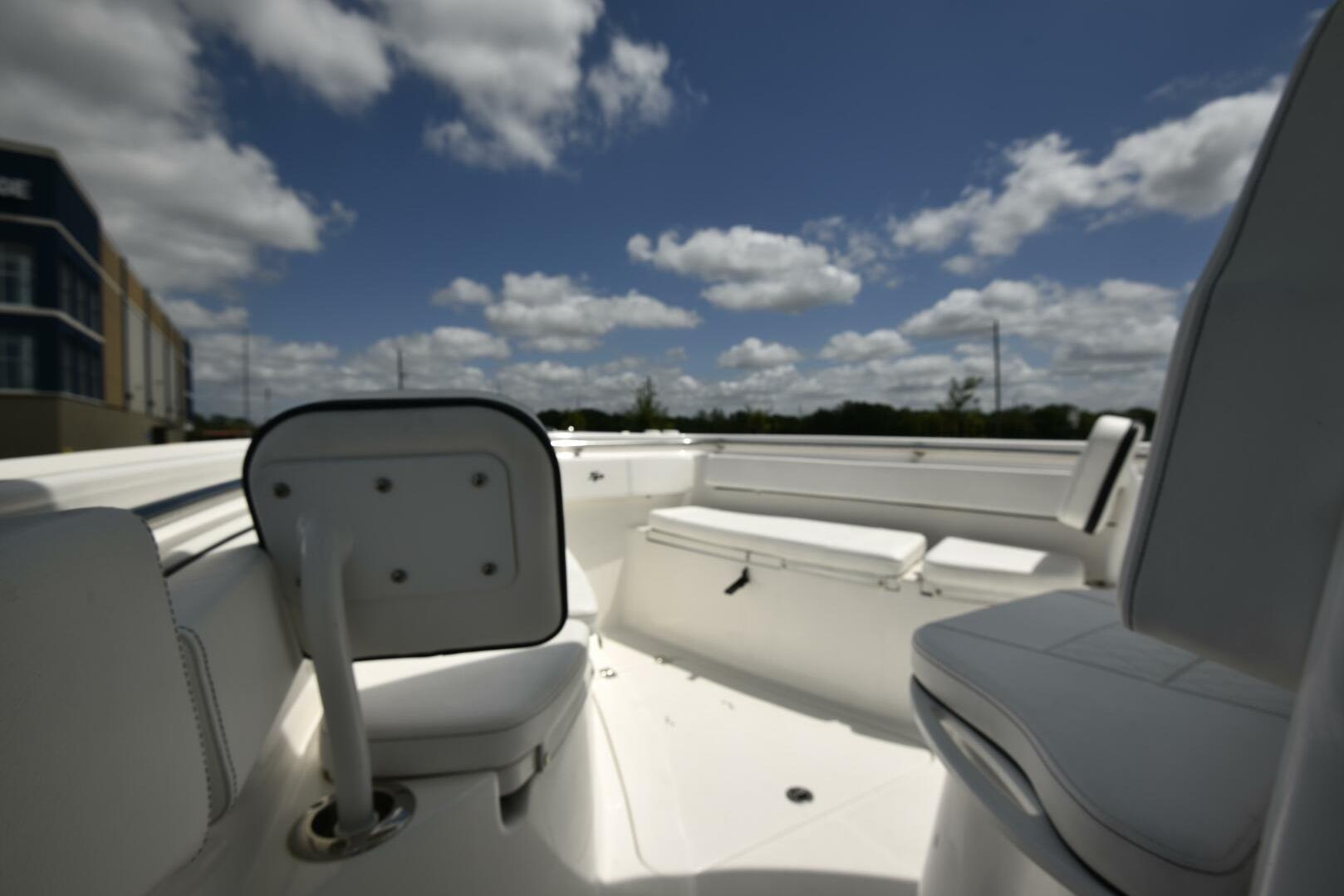 2023 Sea Pro 239 Deep V CC boat interior under a partly cloudy sky.