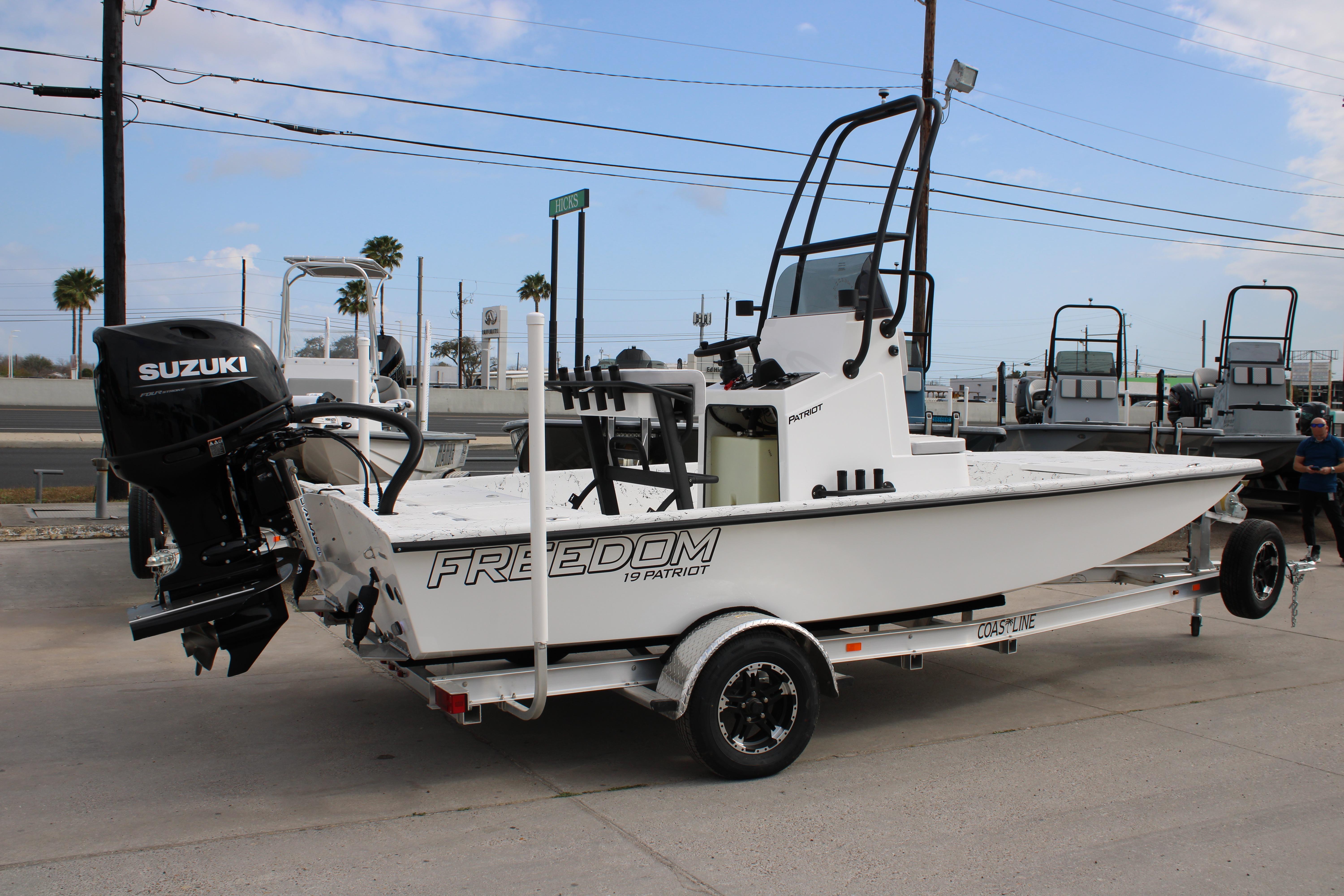 2026 Freedom Boats 19 PATRIOT on trailer with Suzuki outboard motor.
