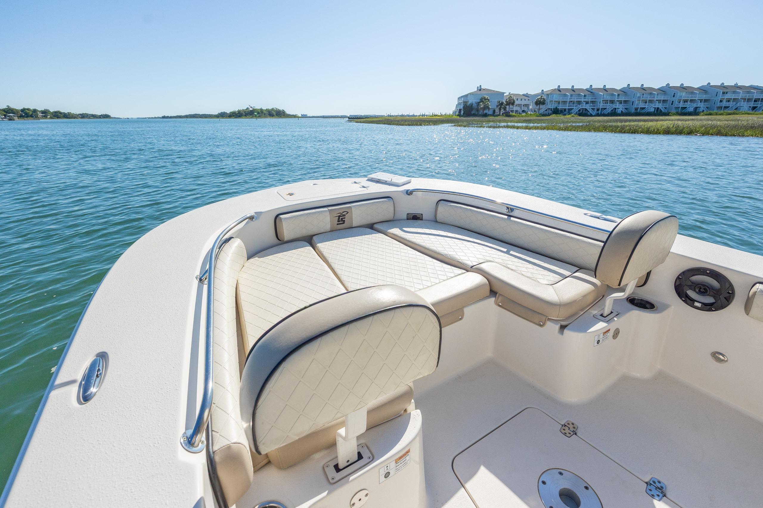 2021 Carolina Skiff 26 Ultra Elite boat interior with seating, on calm water.