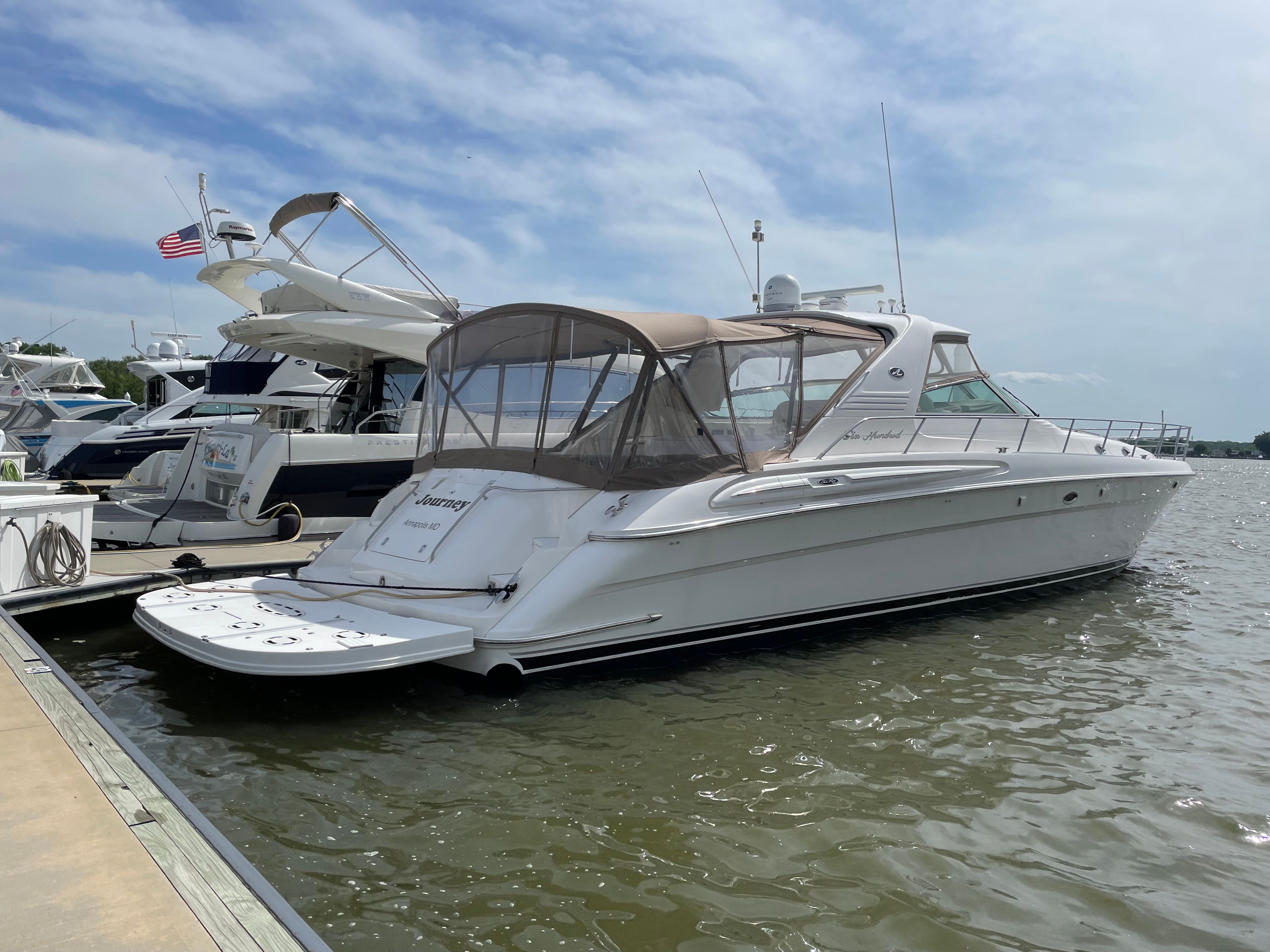 A 2003 Sea Ray S600 Sunsport docked on the water.