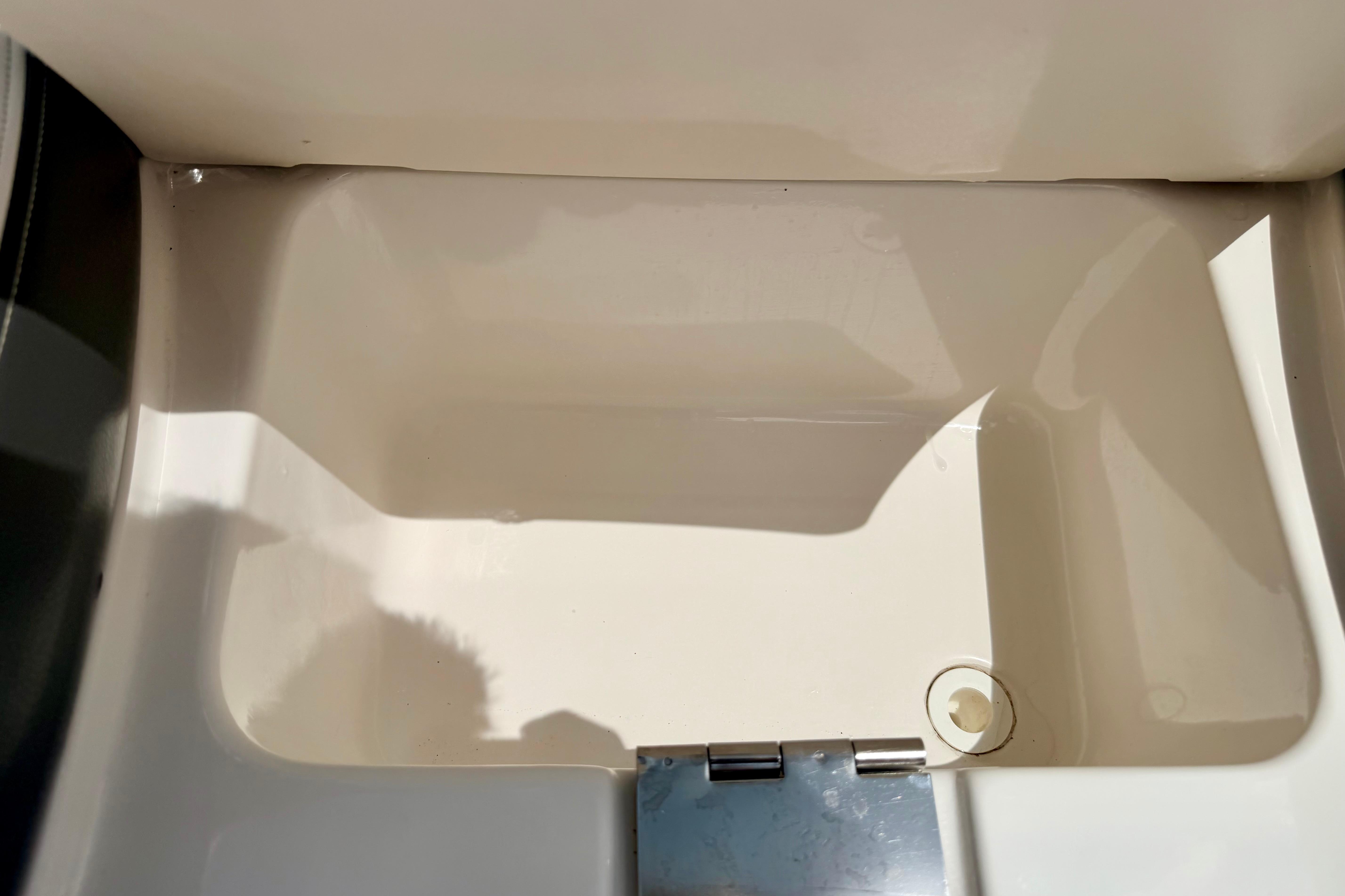Interior compartment of 2015 Chaparral Sunesta 264 boat, featuring a clean, white finish.