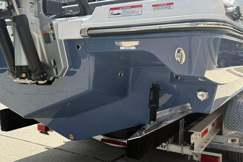 Rear view of a 2026 Monterey Elite 30 OB boat on a trailer.