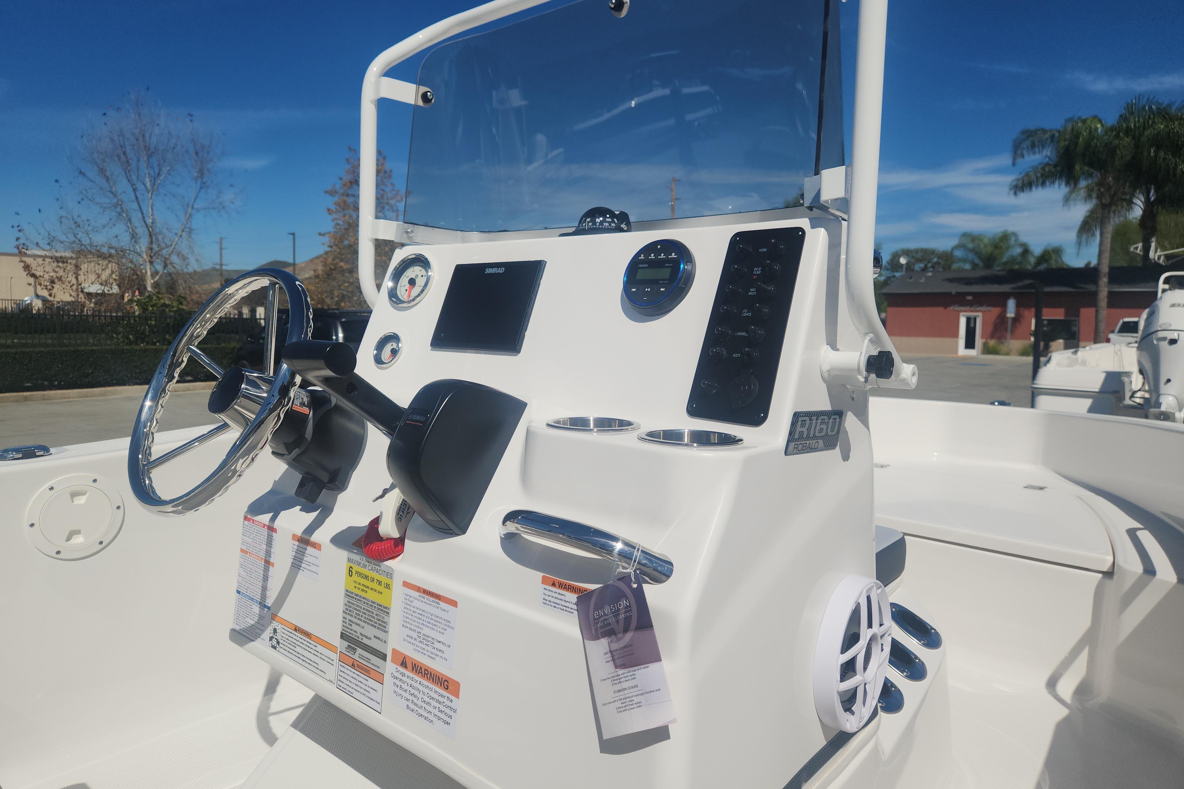 2026 Robalo R160 Center Console boat dashboard with steering wheel and controls.