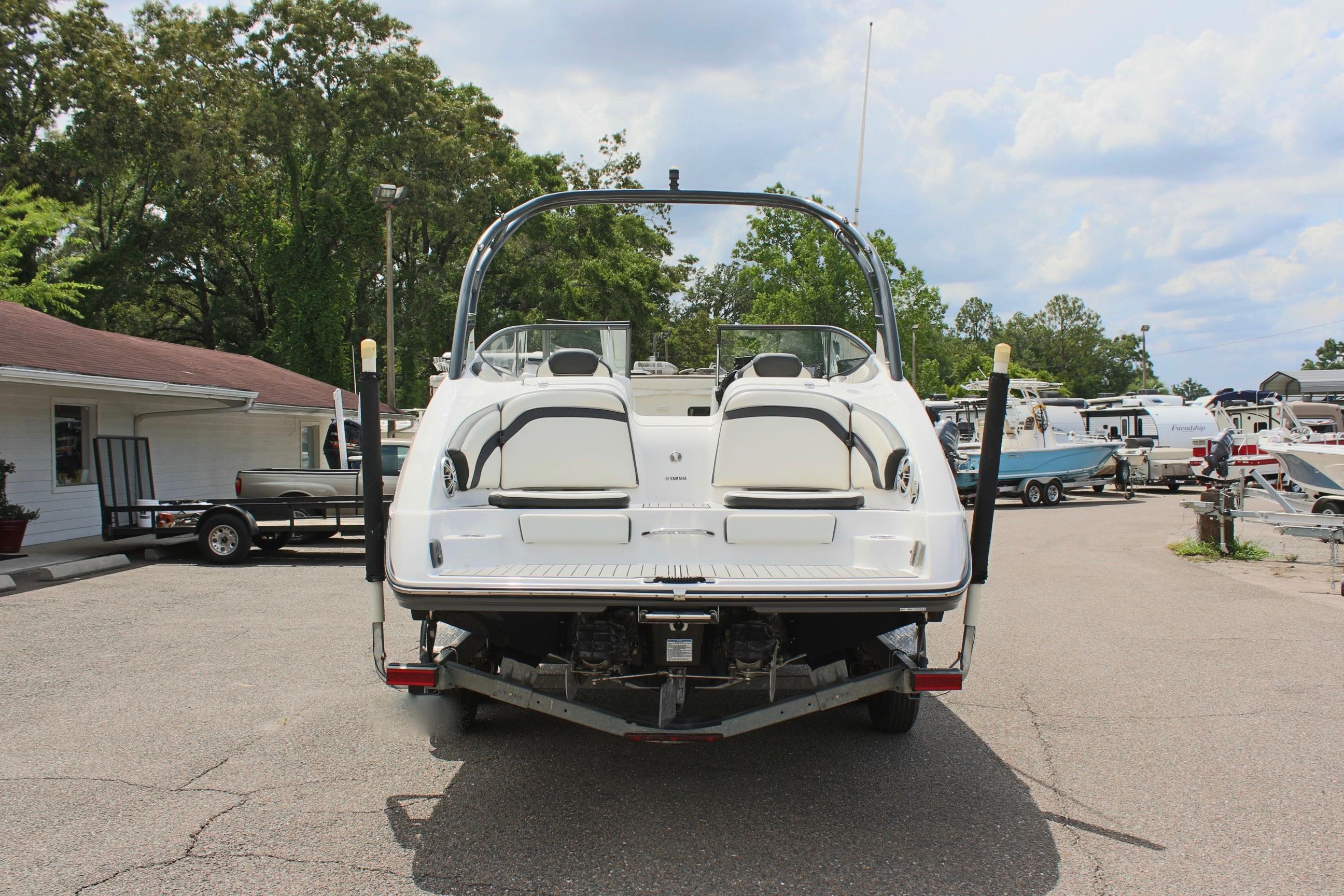 2016 Yamaha Boats 242 Limited S on trailer, rear view, in a marina setting.