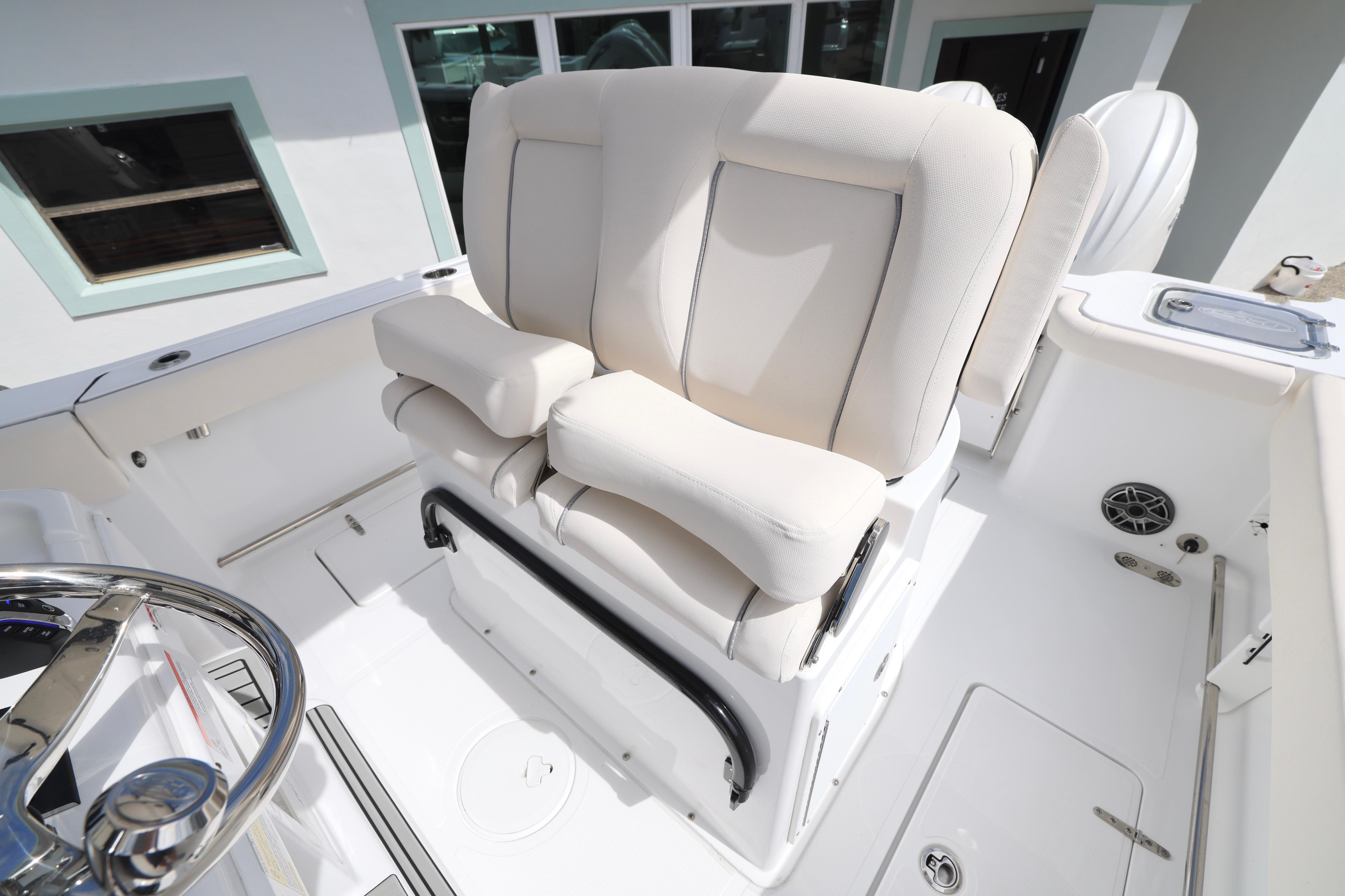 2026 Sea Hunt Gamefish 25 boat interior with plush captain's chair and steering wheel.