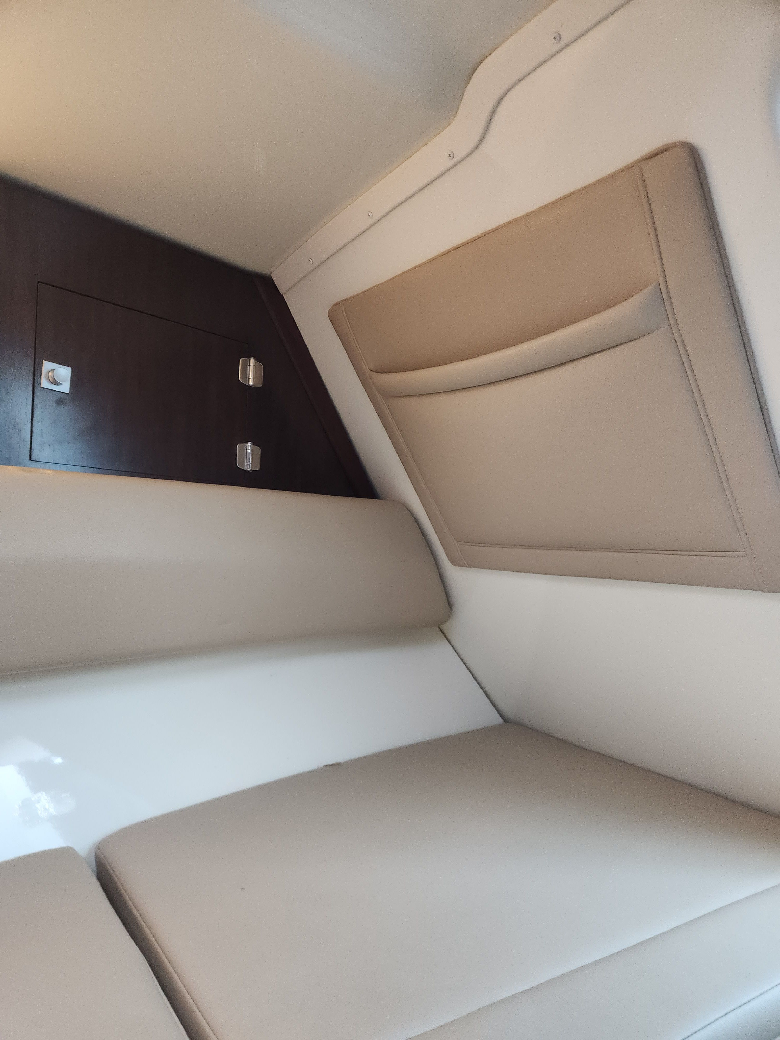 Interior of a 2015 Monterey 268SSC boat with beige upholstery.