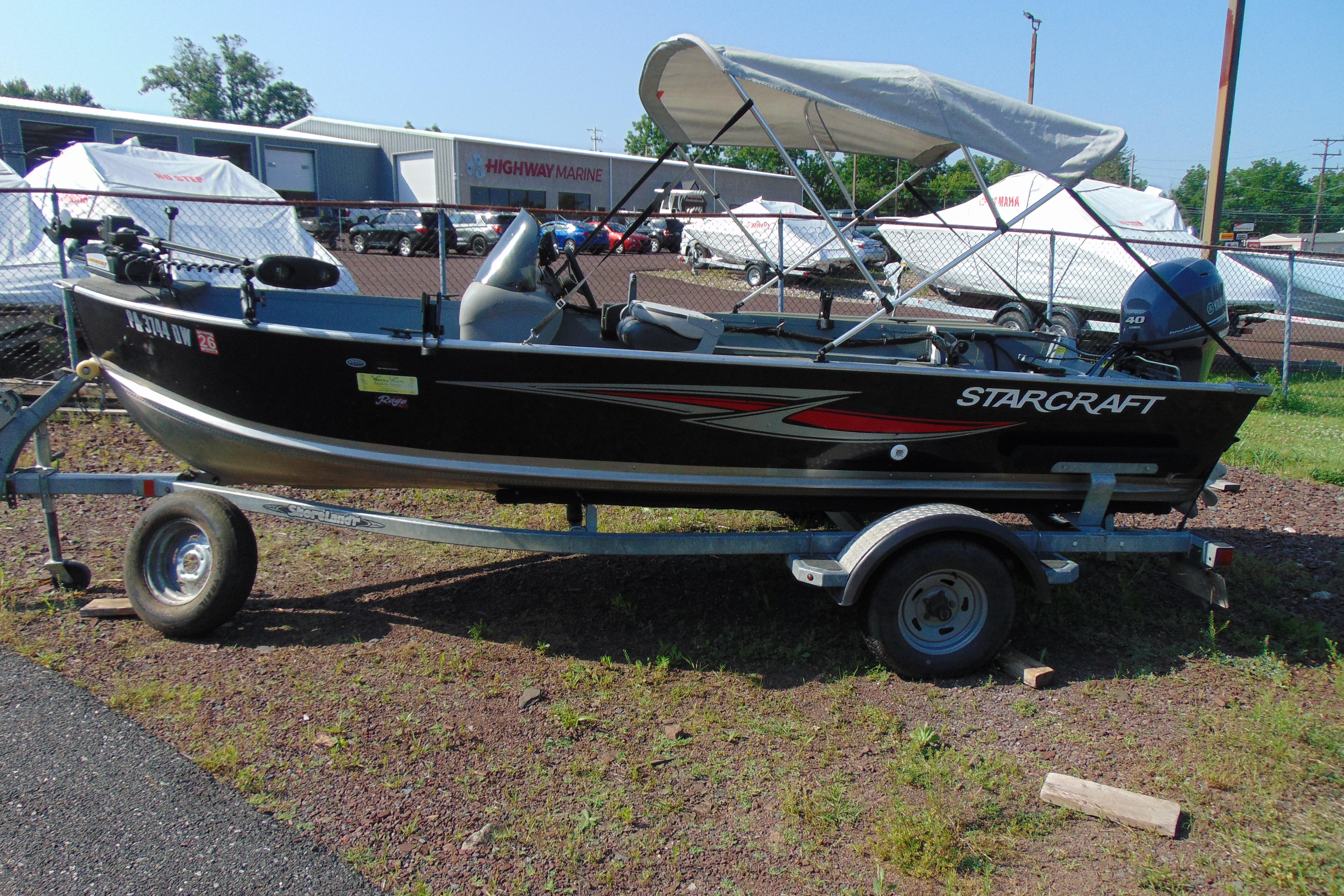 2017 Starcraft SF 16 DLX boat on trailer, parked outdoors near marine dealership.