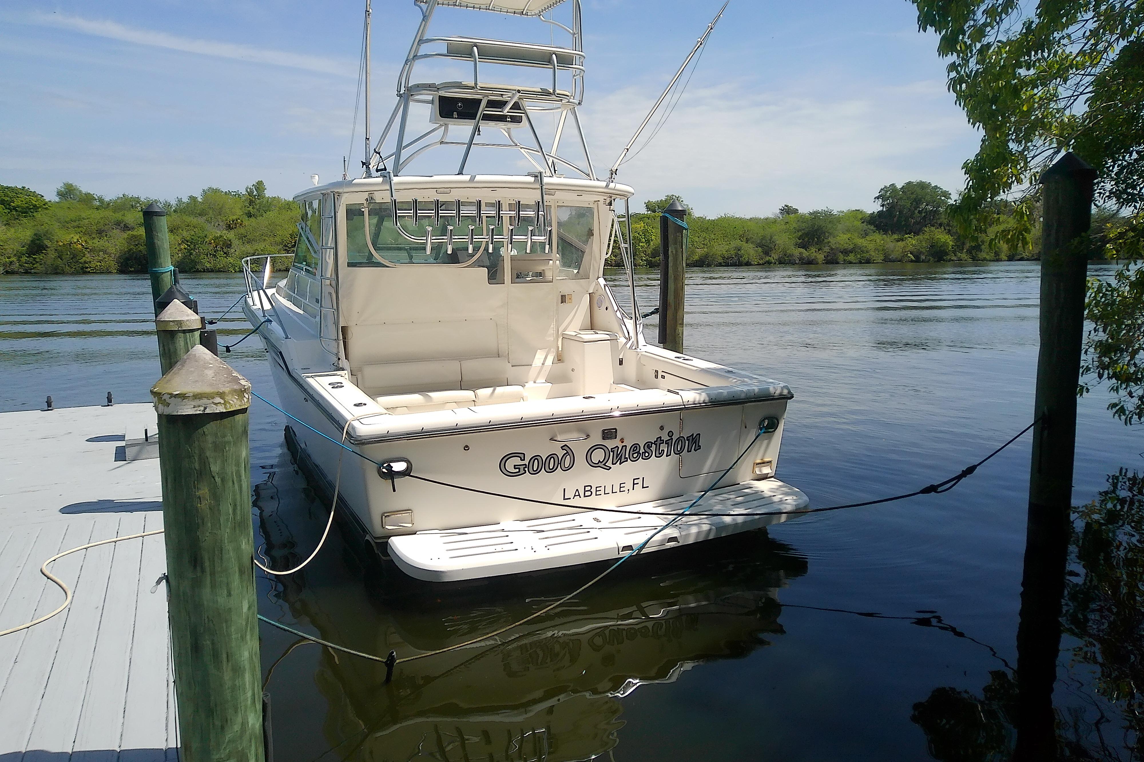 2000 Tiara Yachts 4100 Open docked by a serene riverbank.
