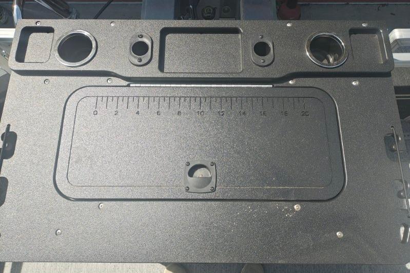 2026 Sun Tracker Fishin' Barge 20 DLX fishing station with integrated ruler and cup holders.