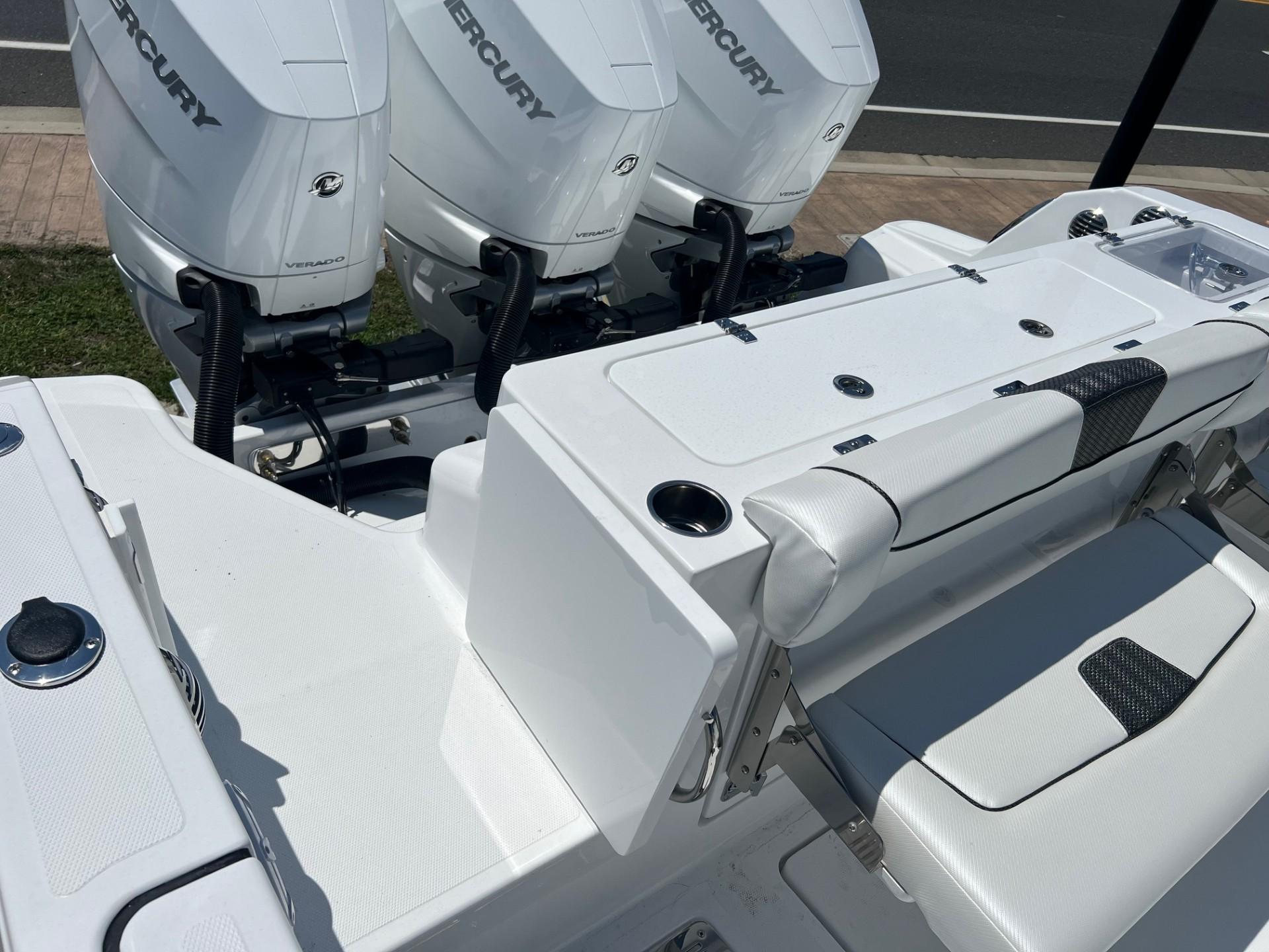 2025 Wellcraft 352 Fisherman boat with triple Mercury engines, white seating, and deck.