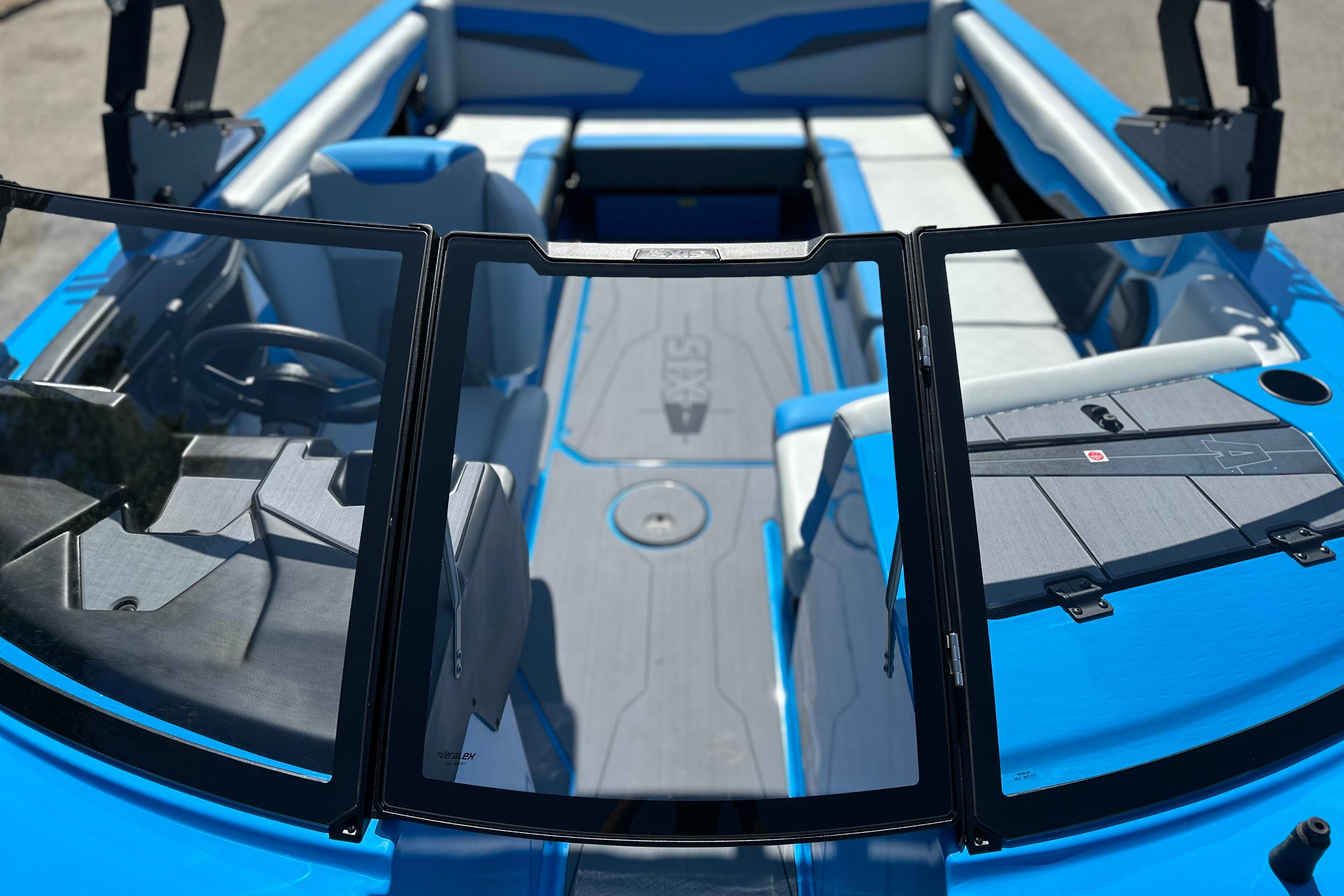 2026 Axis T235 boat interior with blue and gray seating, open windshield, and modern design.