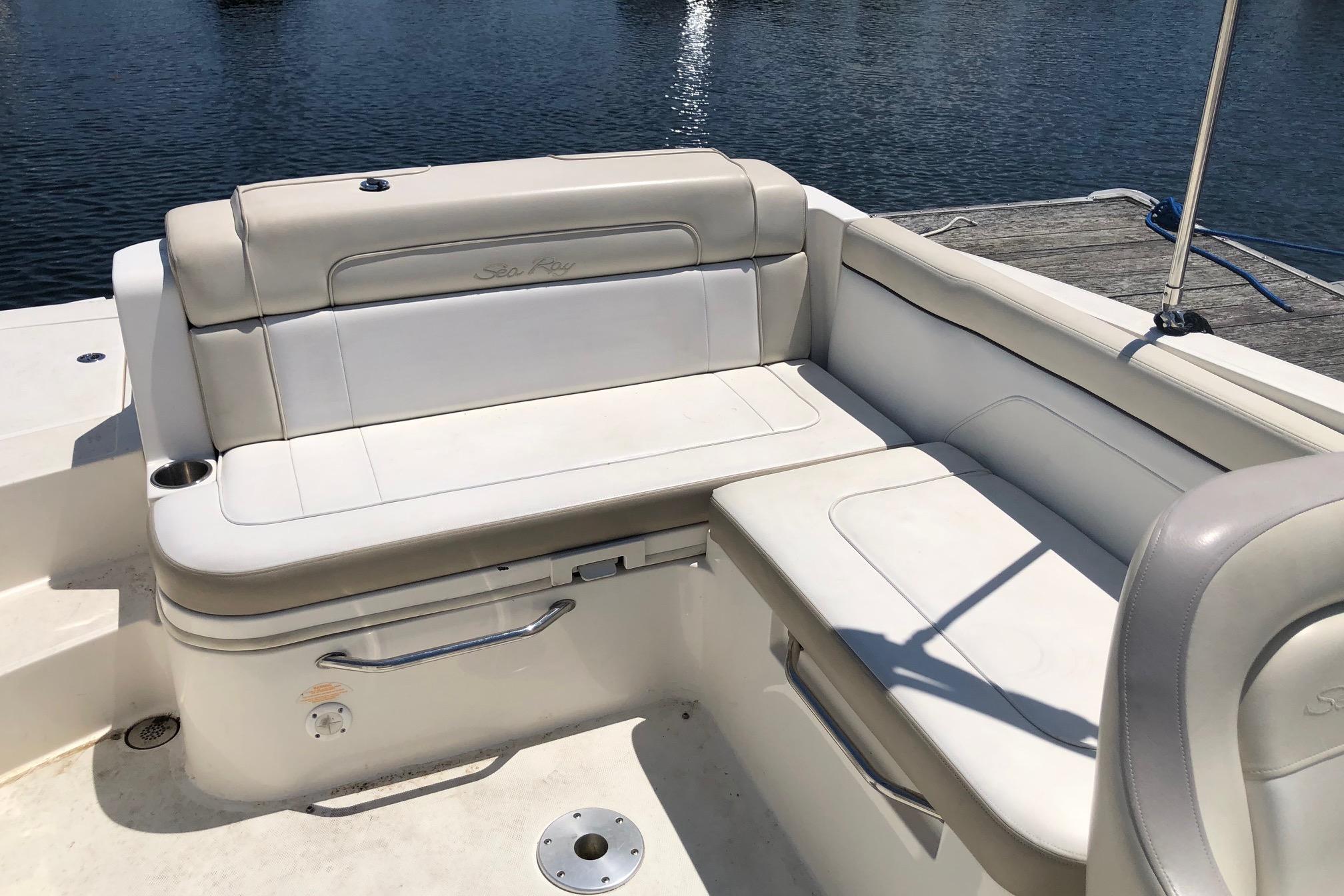 2013 Sea Ray 260 Sundeck boat seating area with beige upholstery by the water.