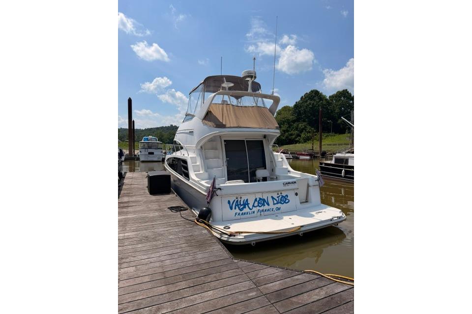 2003 Carver 36 Super Sport yacht docked on a sunny day.