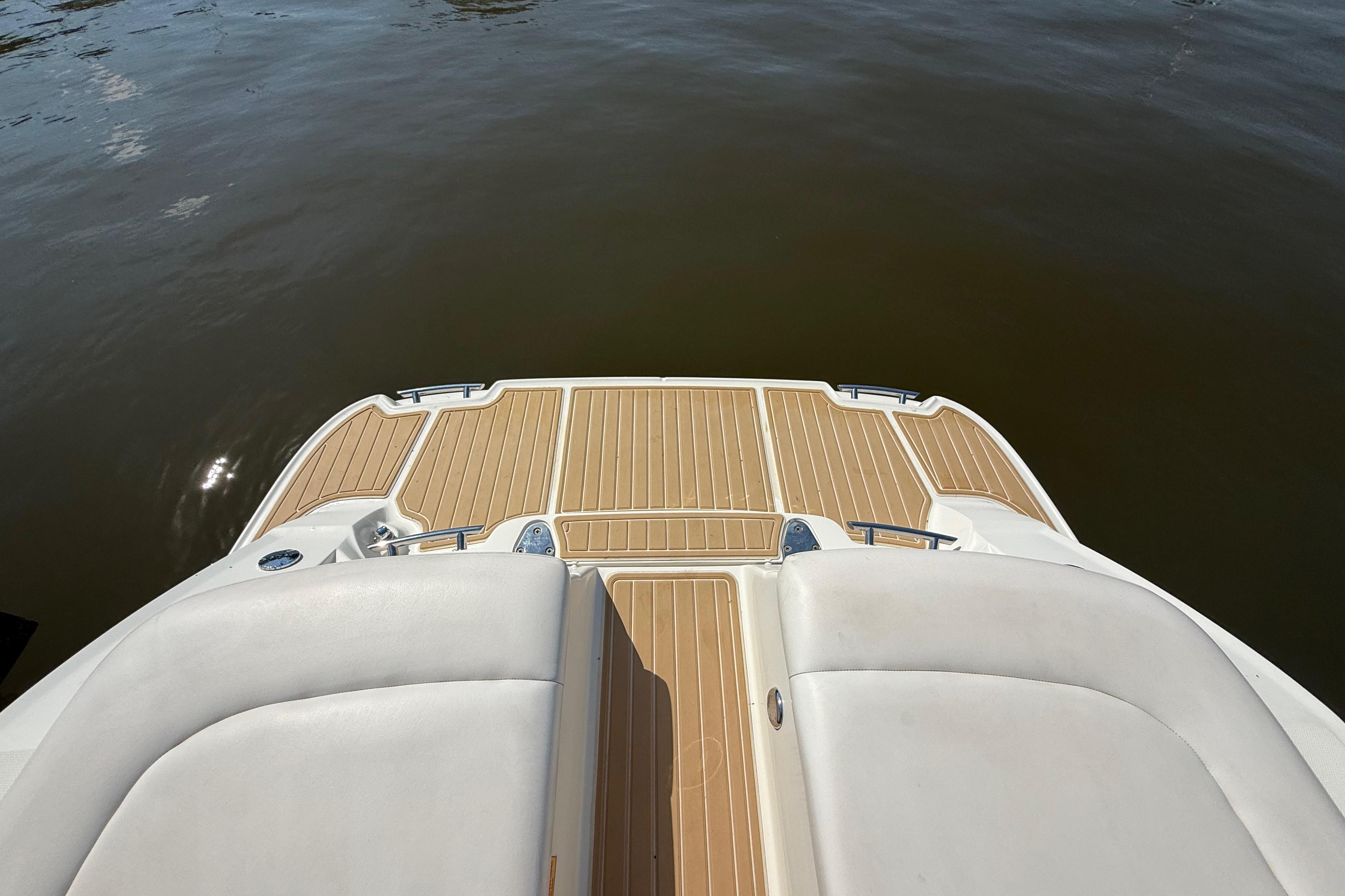 2011 Sea Ray 270 SLX boat deck with teak flooring, overlooking calm water.