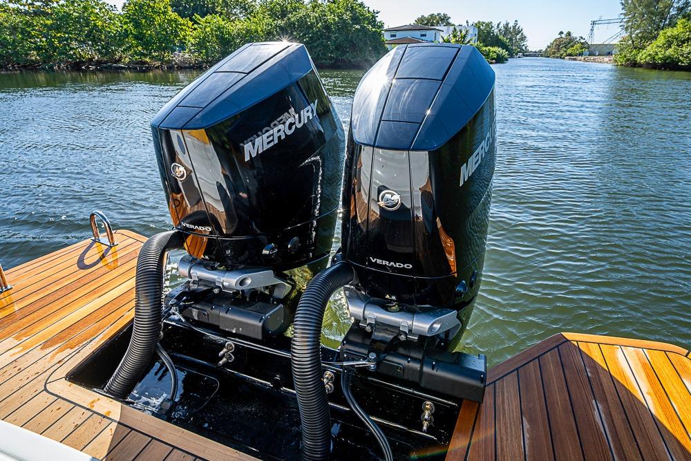 Twin Mercury Verado engines on 2025 SACS Strider 11 boat, docked on a sunny day.