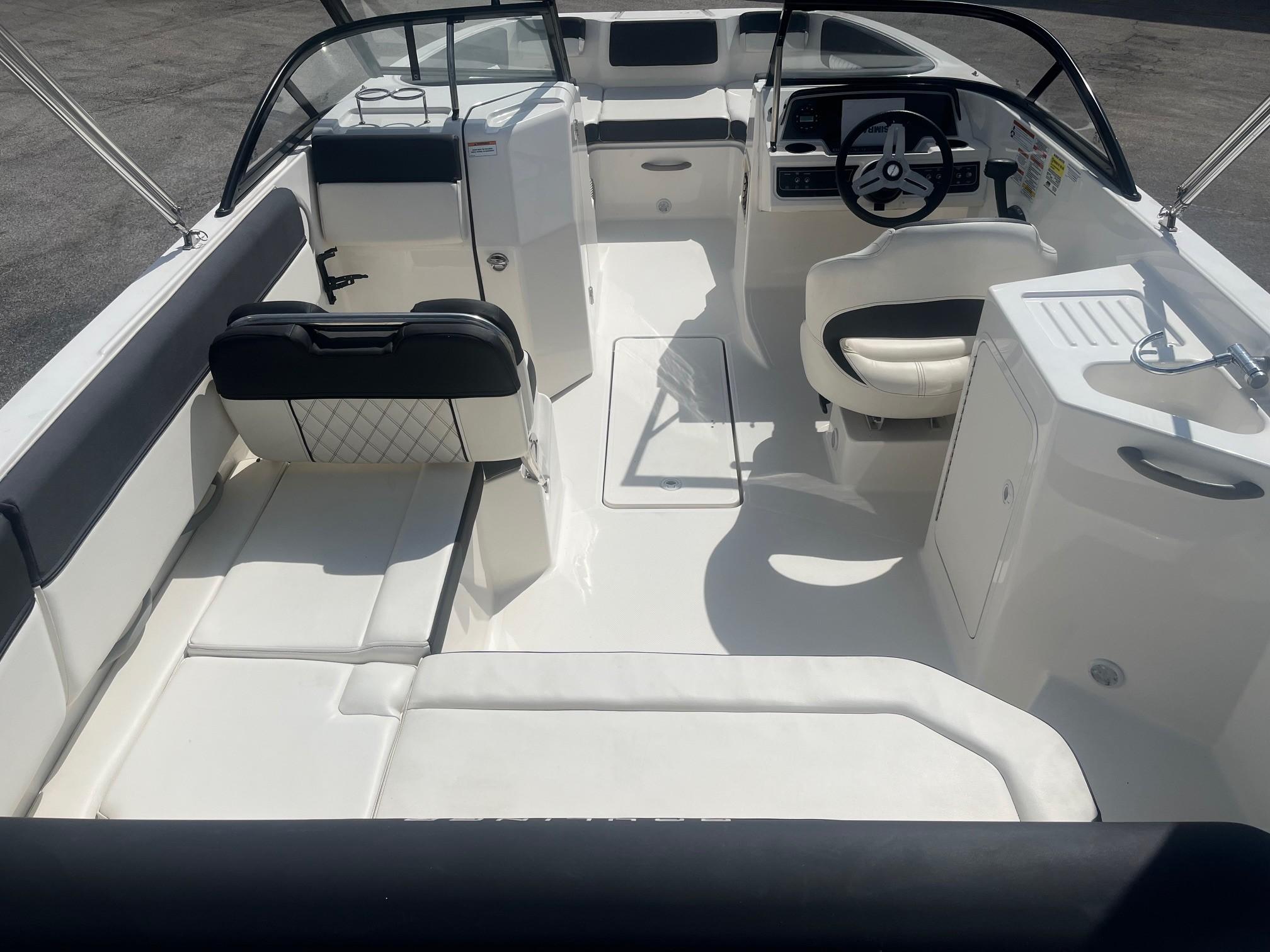 2022 Bayliner DX 2200 boat interior with seating, steering wheel, and sink.