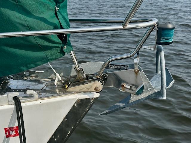 Bow of a 1998 Freedom 35 sailboat with Rocna anchor over water.
