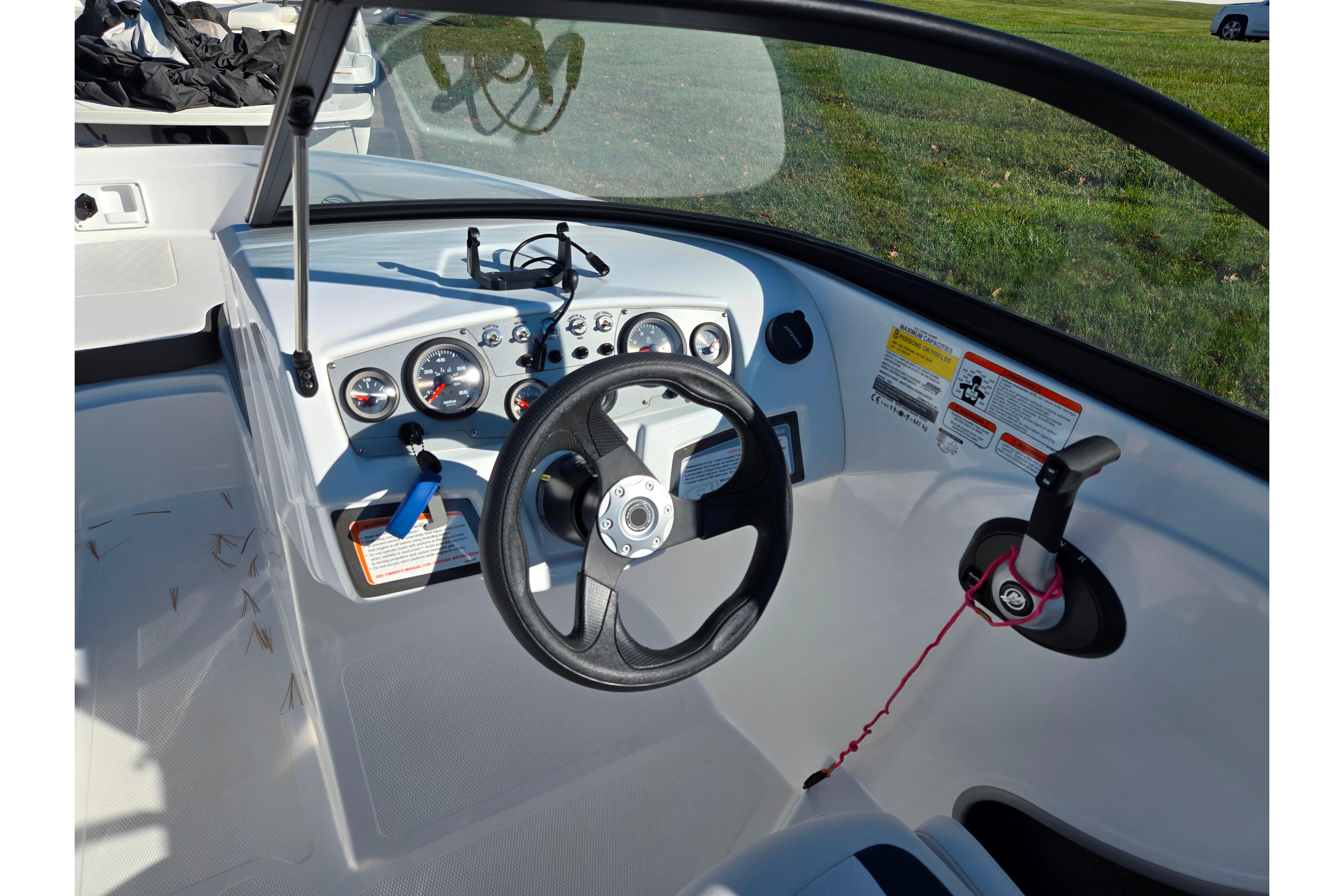 2023 Tahoe 185 S boat dashboard with steering wheel and control panel.