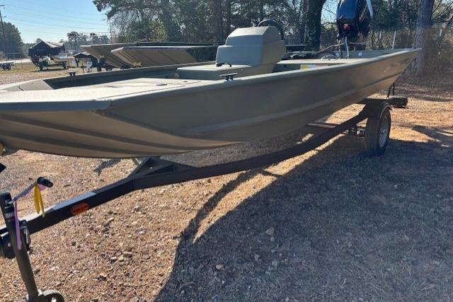 2026 Tracker Grizzly 1648 SC boat on trailer, parked outdoors.