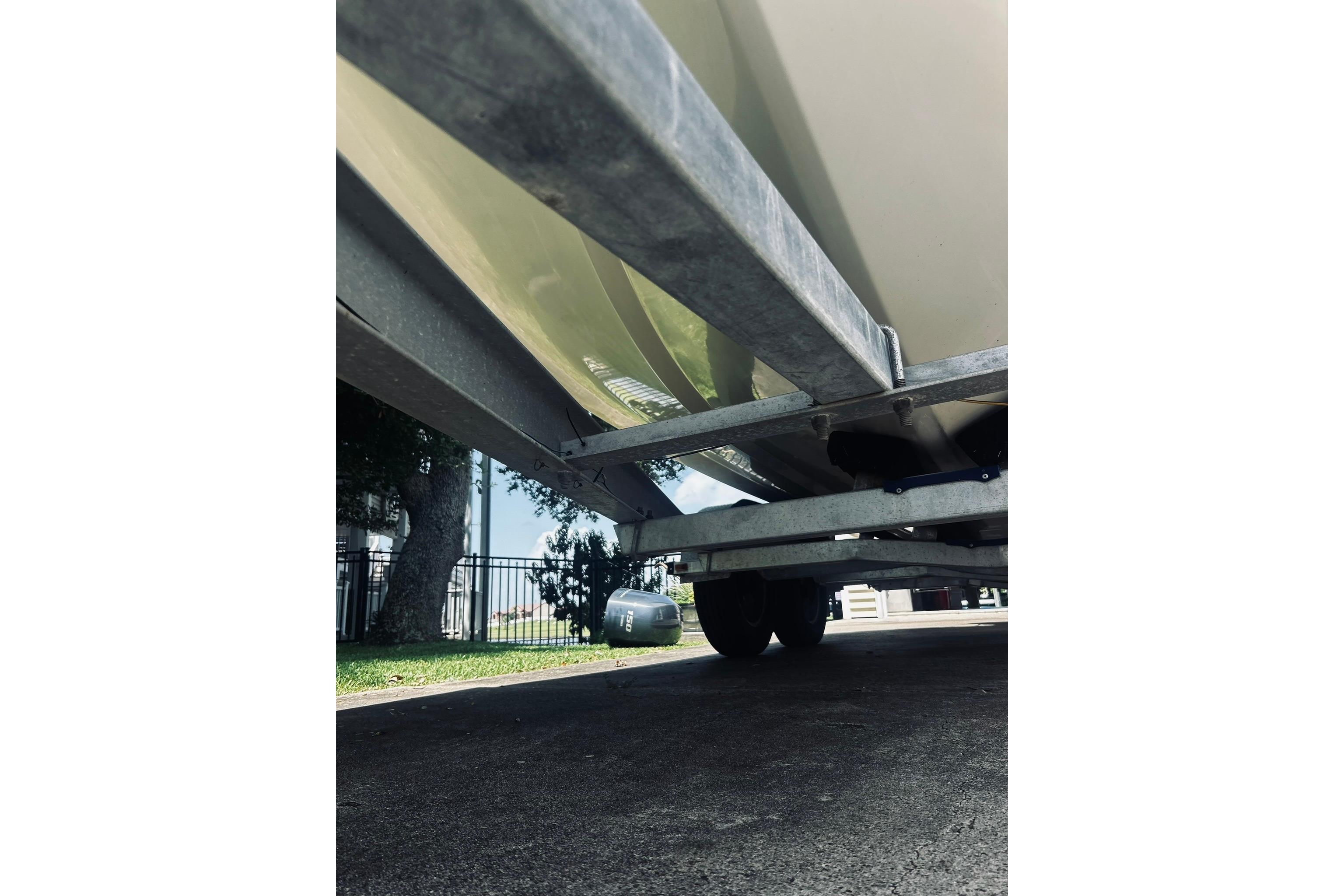 Underneath view of a 2013 Hurricane SunDeck Sport 201 OB boat on a trailer.