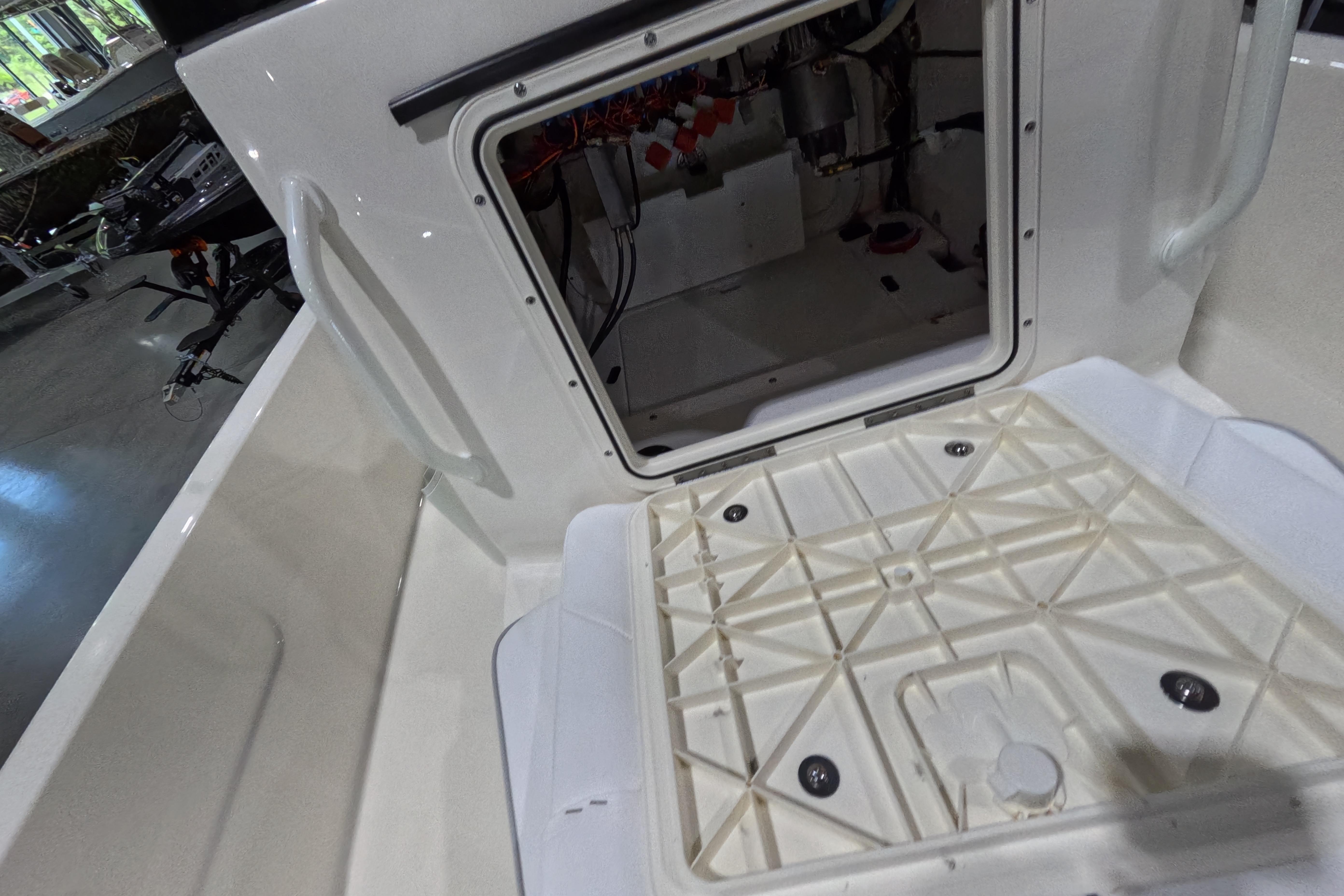 Open hatch of 2026 Skeeter SX230 boat showing interior components.