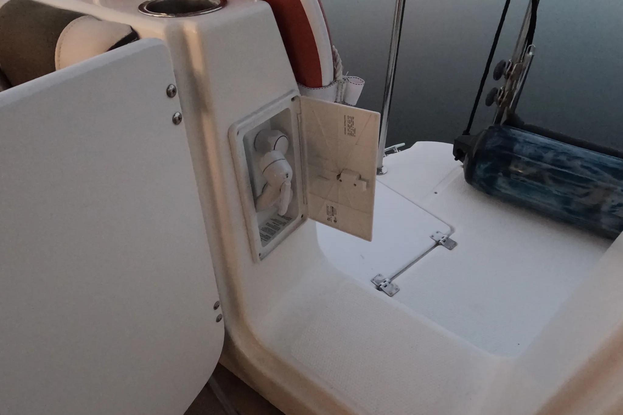 2015 Ranger Tugs R-29 S boat deck with open storage compartment and safety equipment.