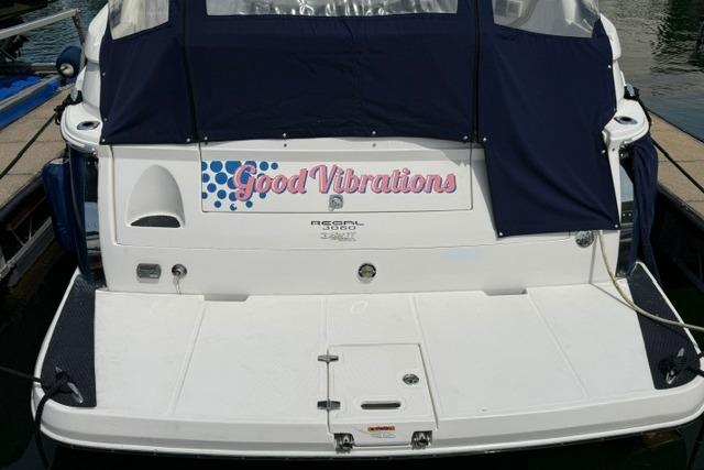 2010 Regal 3060 Window Express boat named "Good Vibrations" docked at marina.