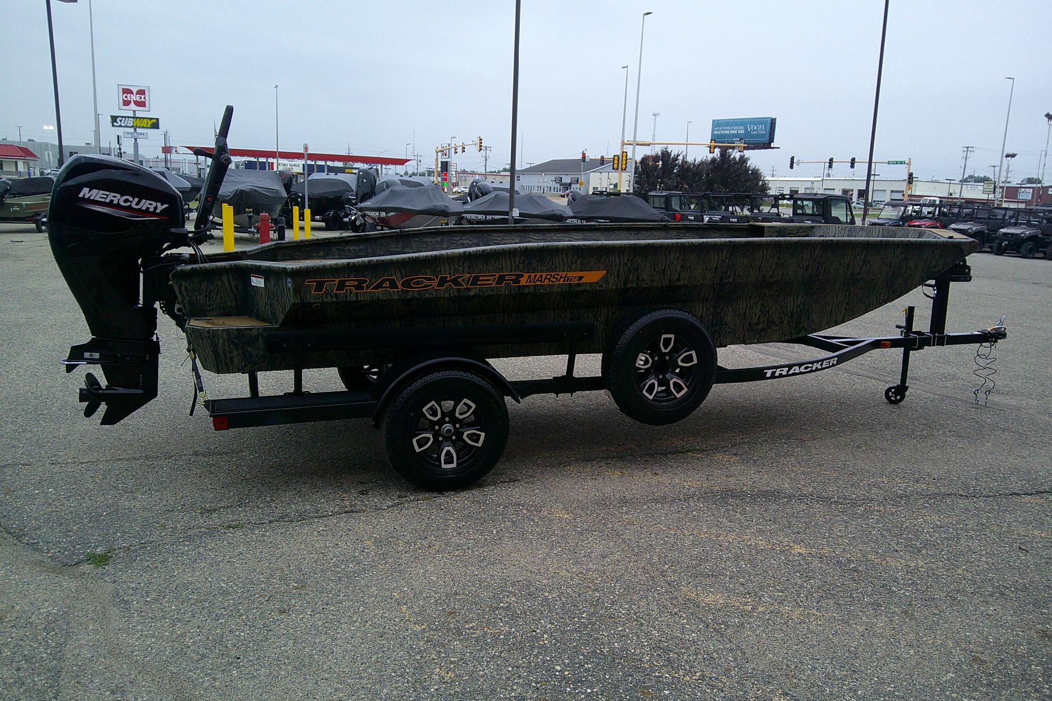 2026 Tracker Grizzly 1756 T Marsh boat with Mercury engine on trailer in parking lot.