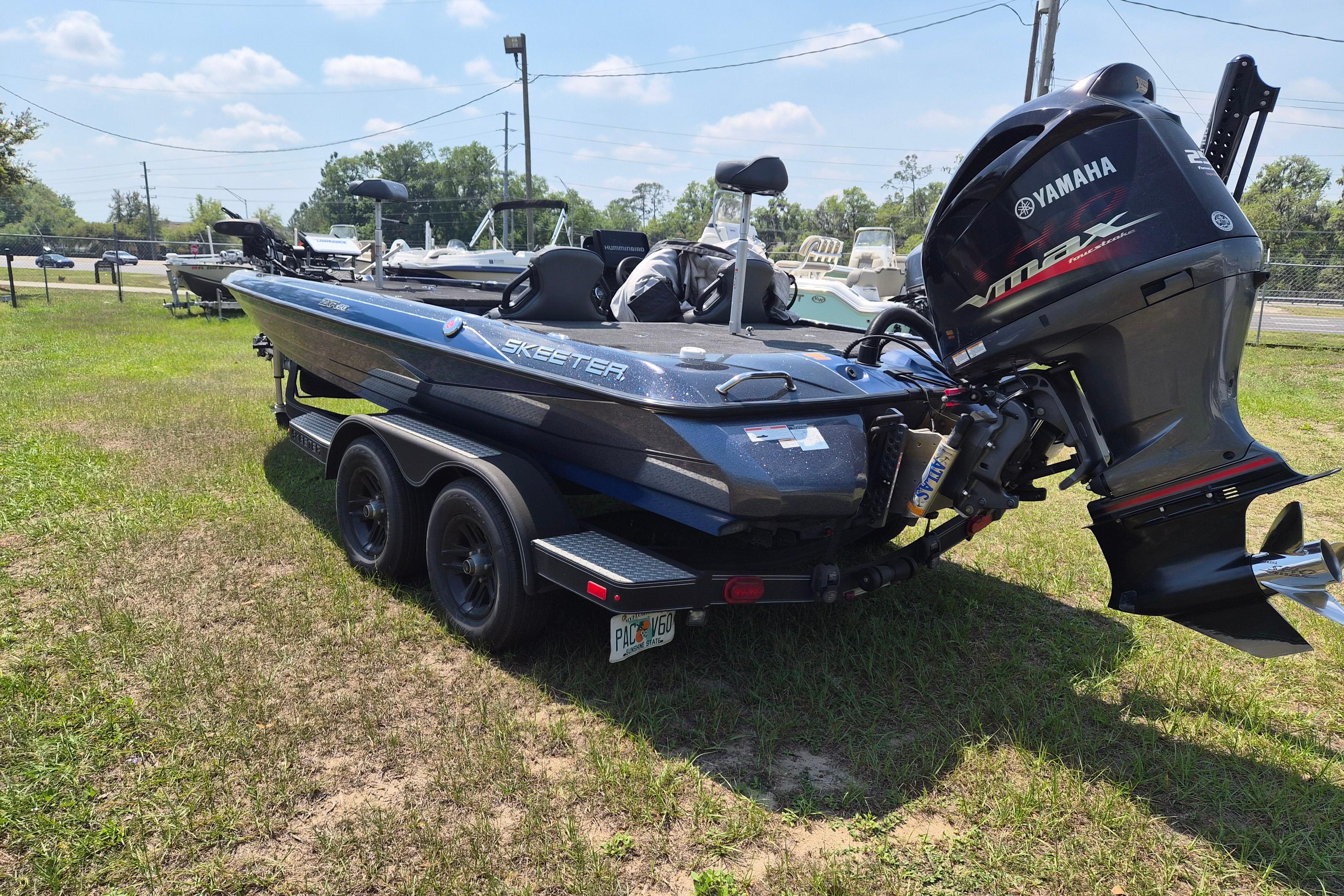 2021 Skeeter ZXR20 boat with Yamaha VMAX engine on grassy area.