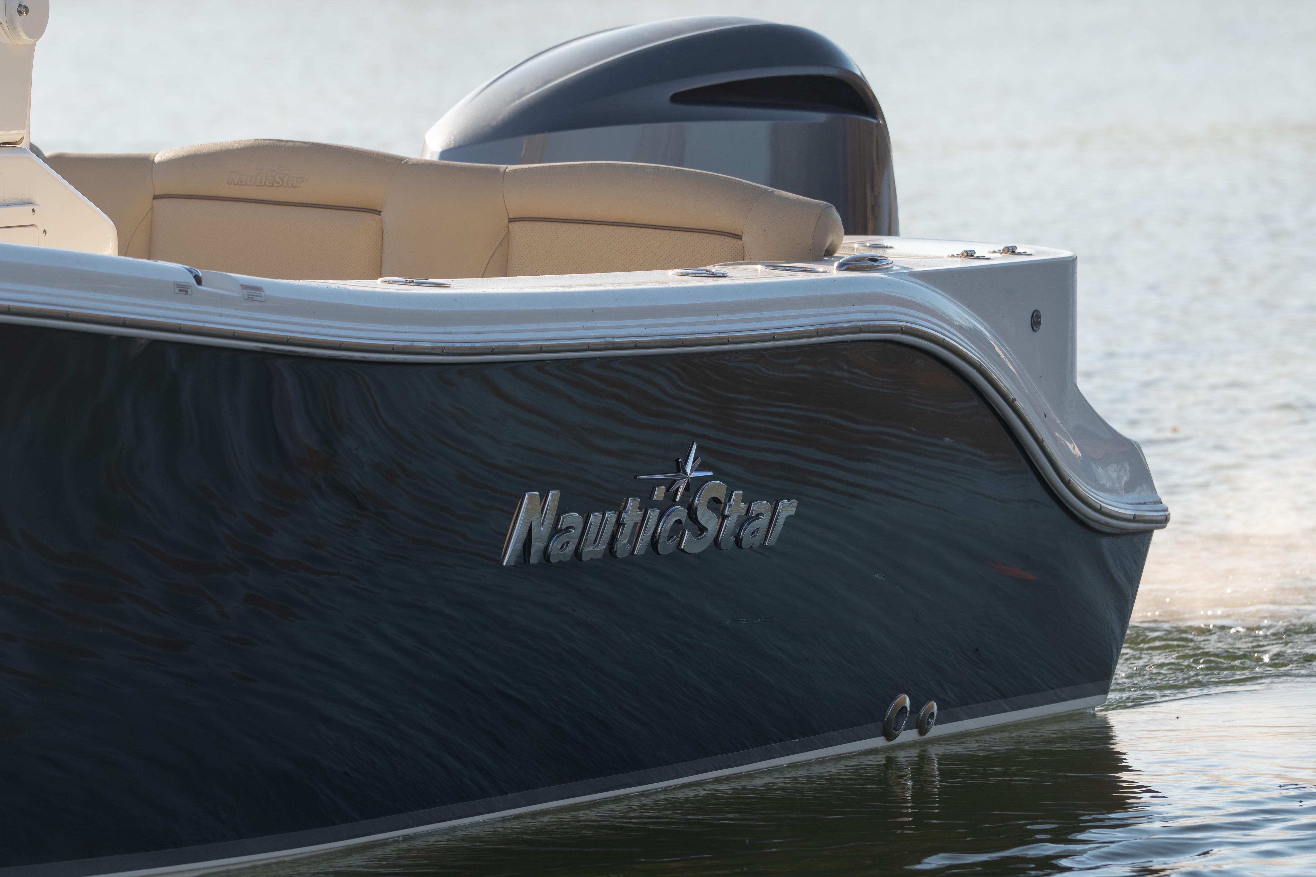 2020 NauticStar 2602 Legacy boat on water, showcasing sleek design and branding.