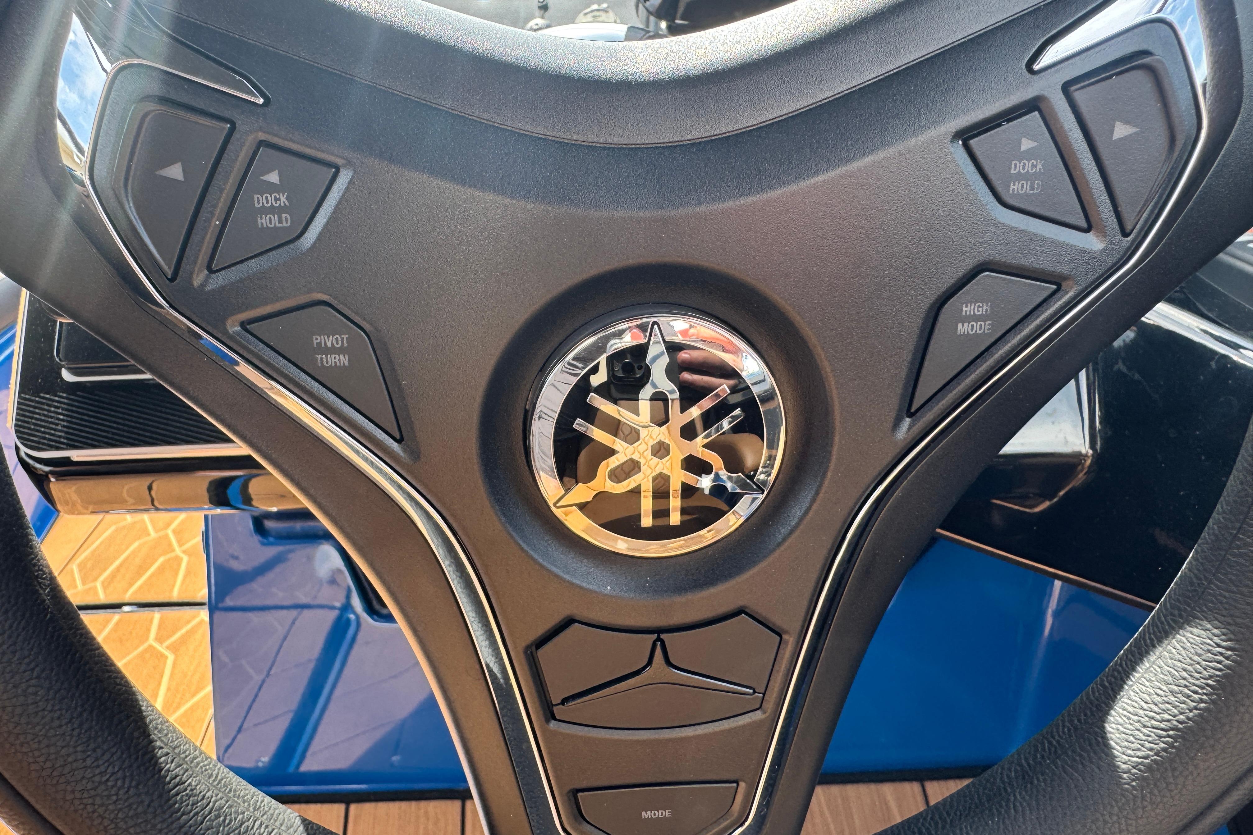 Steering wheel of 2026 Yamaha Boats 255XD with control buttons and logo.